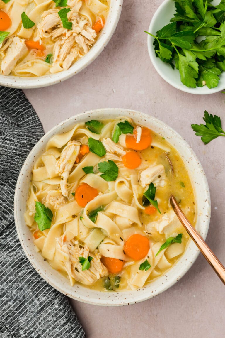 A bowl of gluten-free chicken noodle soup.