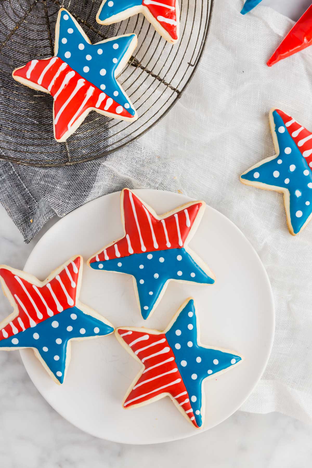 An aerial view of gluten-free 4th of july star sugar cookies with a flag design.