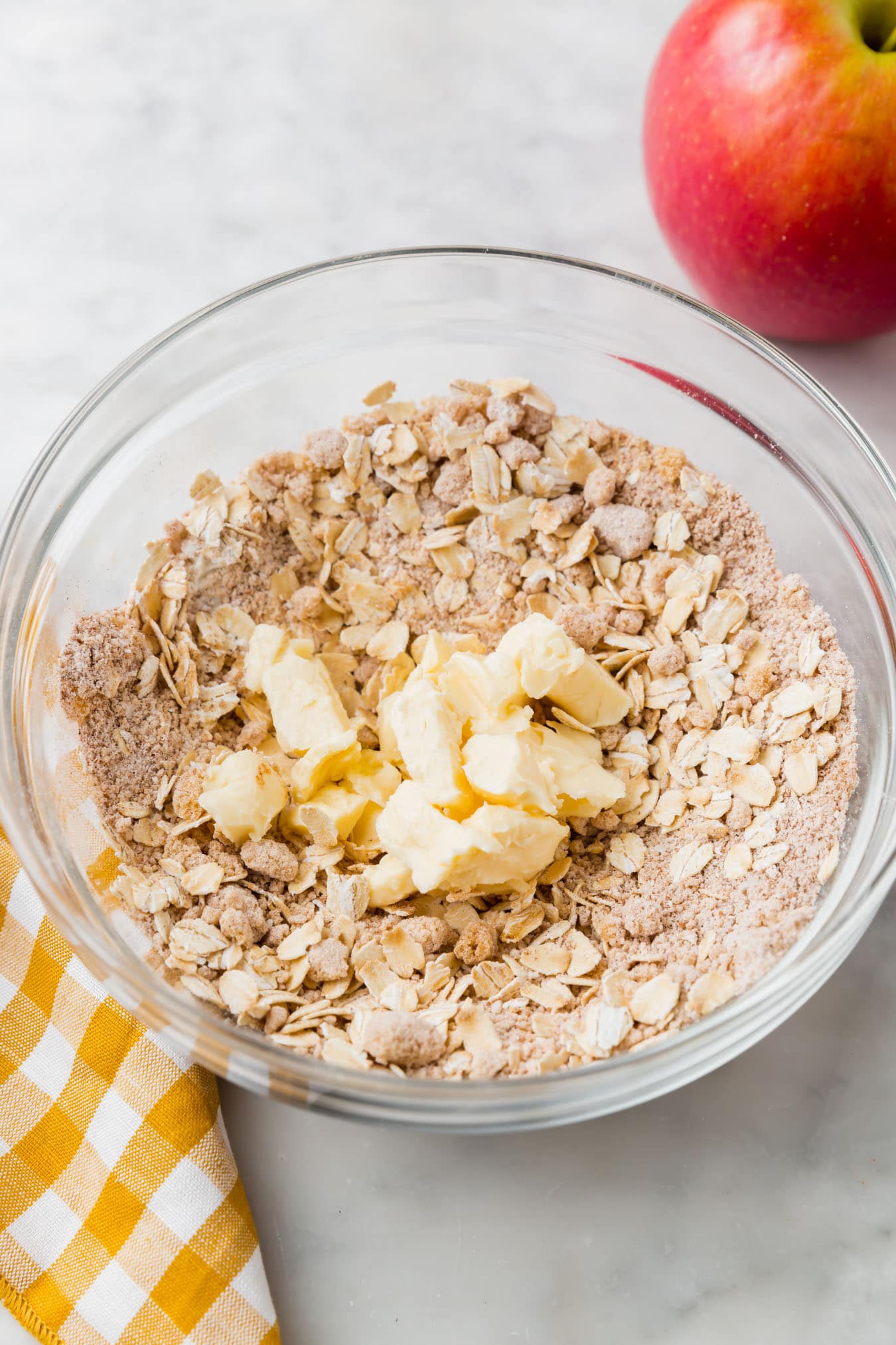 A bowl of gluten-free streusel ingredients with chunks of butter in it.