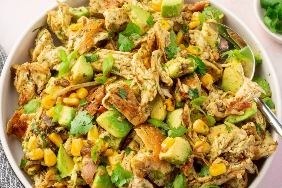 A large bowl of avocado chicken salad on a countertop.