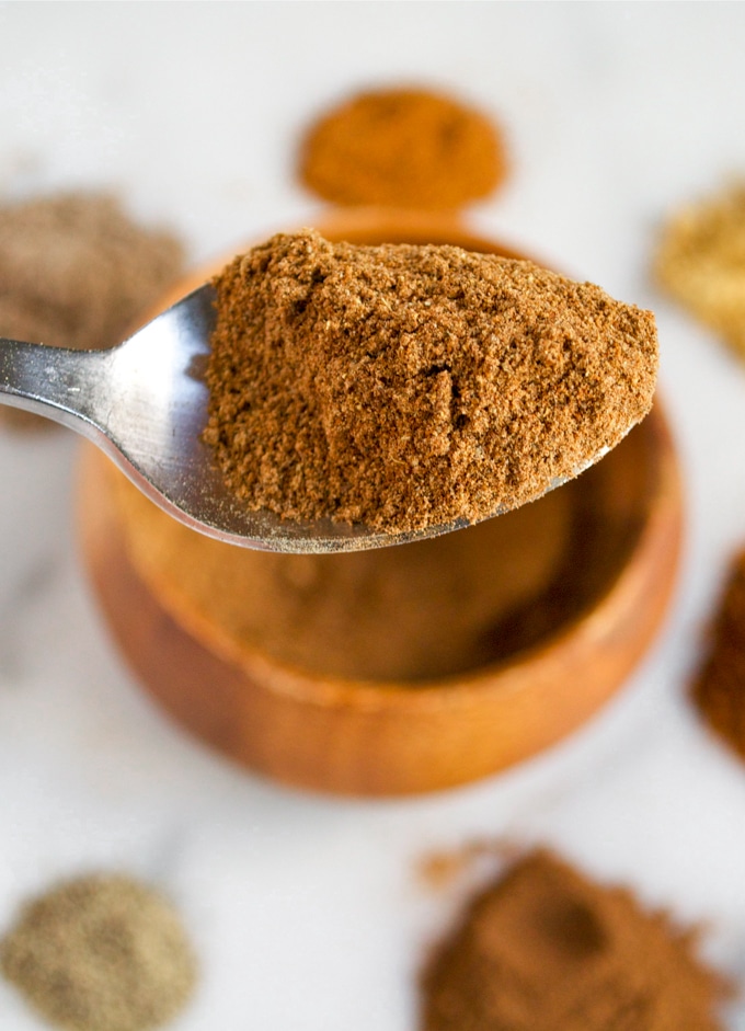 A spoon full of chai spice mix.