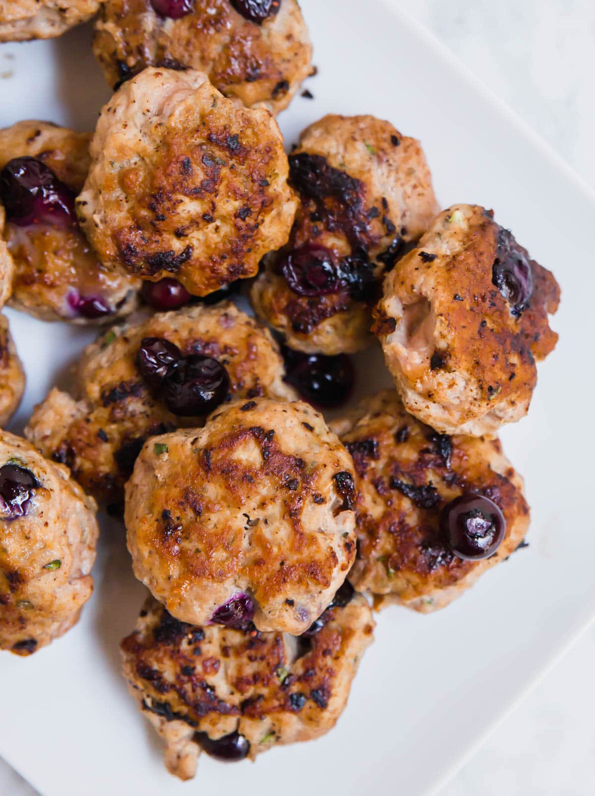A photo of a platter with blueberry turkey breakfast sausages on it.