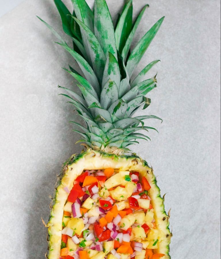This pineapple salsa served in a pineapple boat is a serious show stopper! Not to mention delicious, too! It's naturally gluten-free, dairy-free, and vegan - making it the perfect party appetizer for all of your friends! Get the recipe at Zimeb www.adashofmegnut.com.