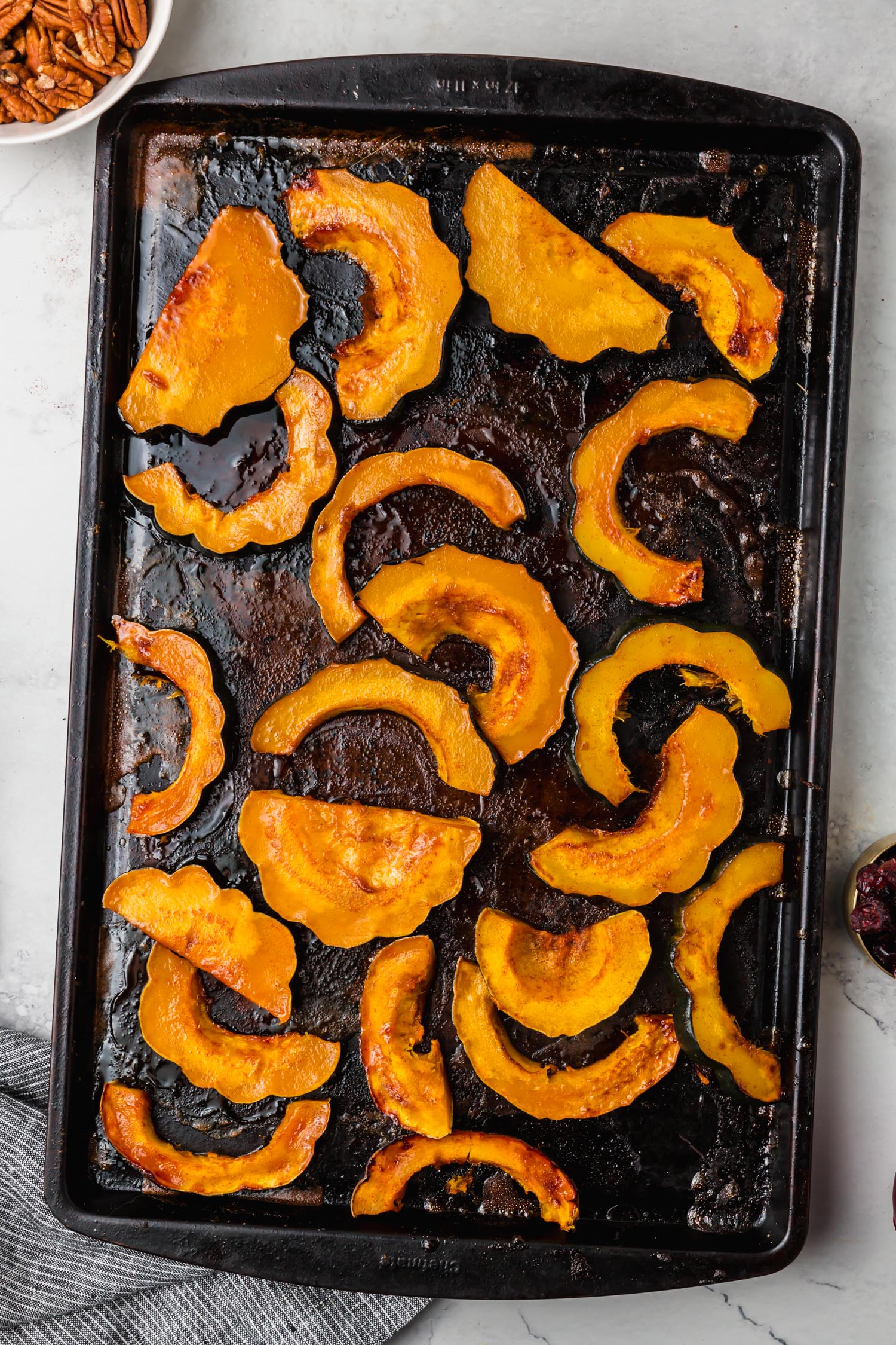 Maple roasted acorn squash on a sheet pan.