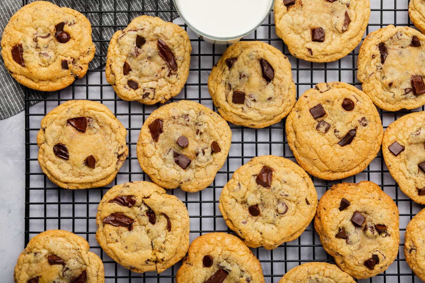 Gluten-free chocolate chip cookies cooling on a rack.