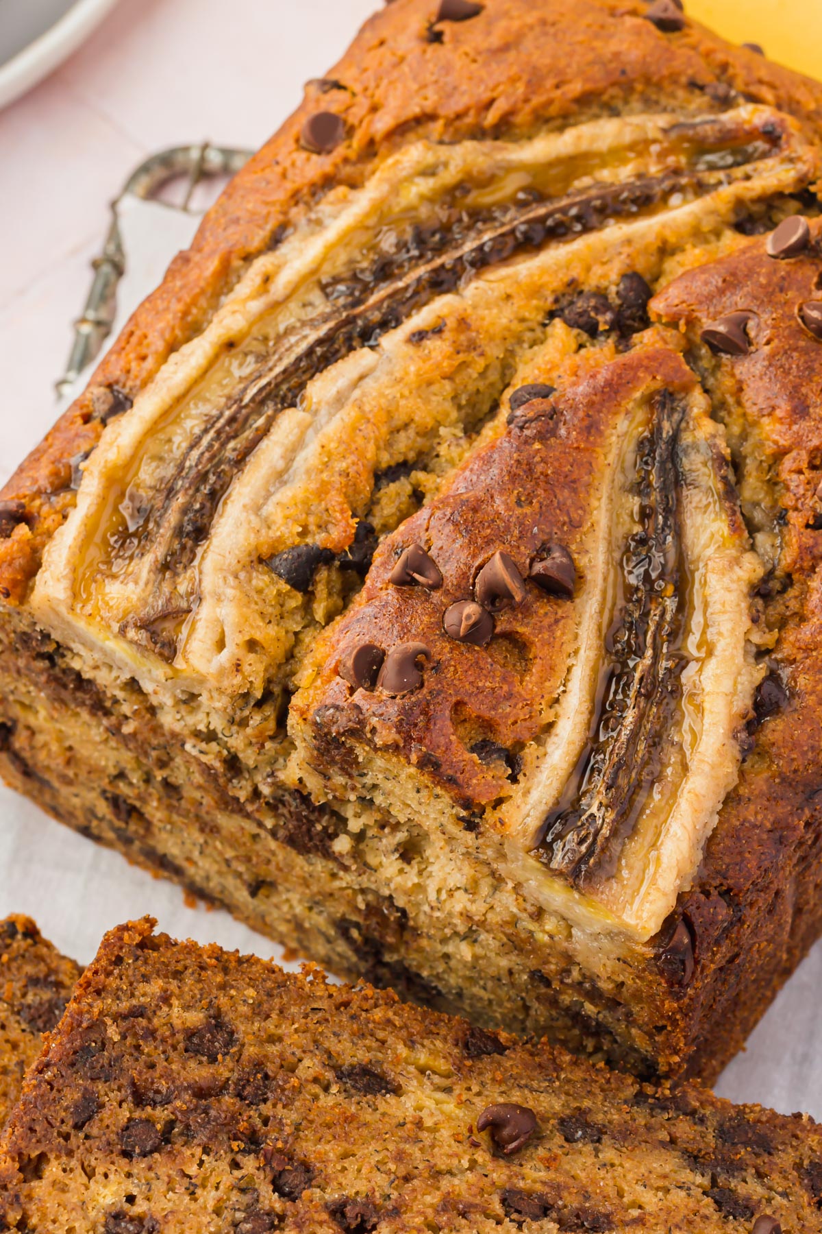 A loaf of gluten-free banana bread with chocolate chips sliced in half.