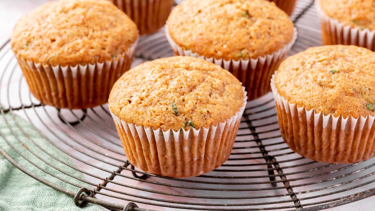 A closeup of gluten-free zucchini muffins on a round cooling rack.