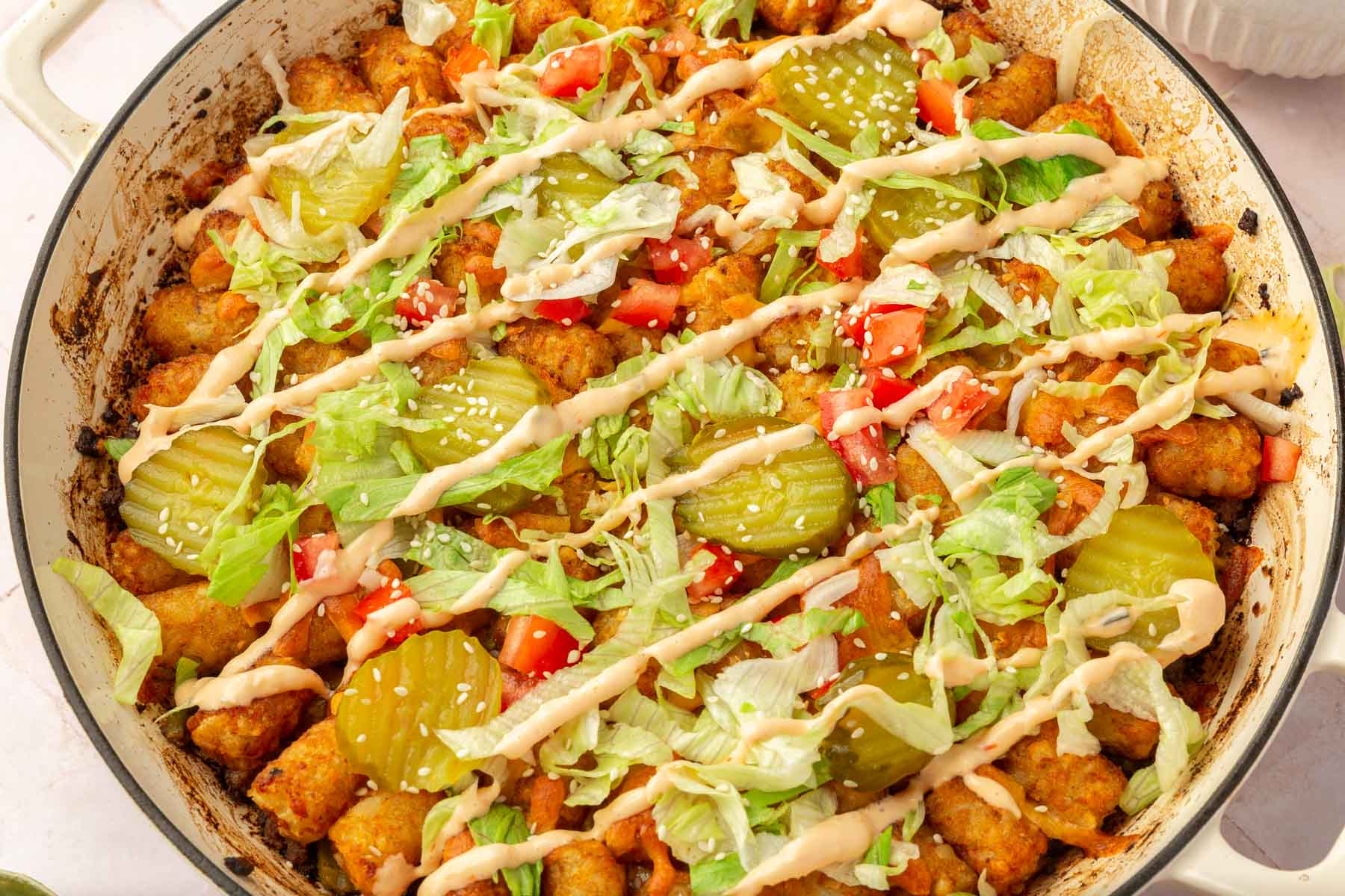 A large round braising pan with big mac casserole in it.