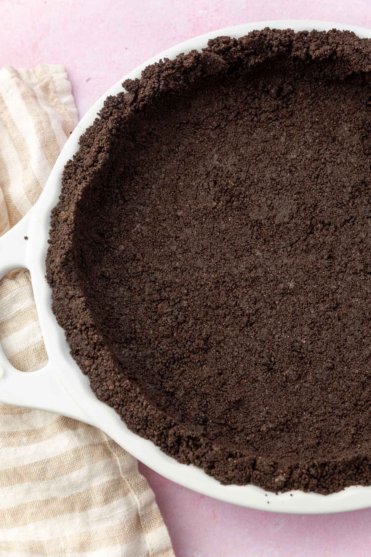 A gluten-free Oreo pie crust pressed into a white tart pan.
