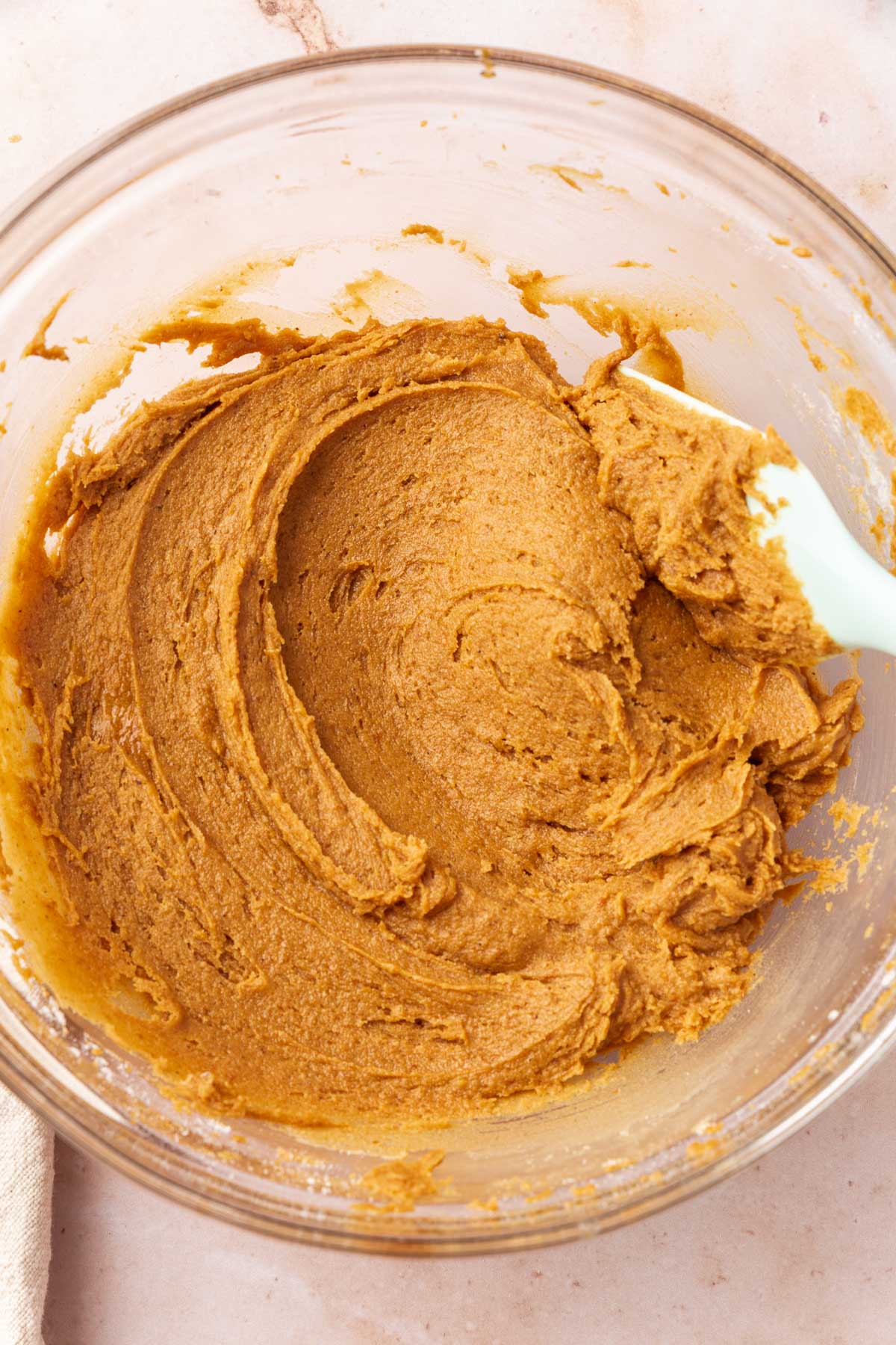 Gluten free pumpkin cookie dough in a glass bowl.