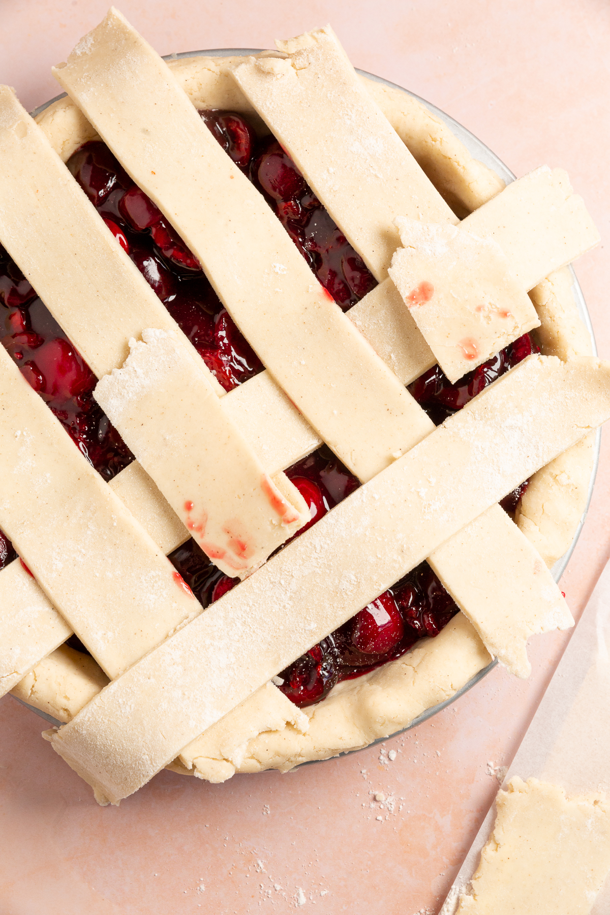 Gluten-free cherry pie with a lattice crust almost complete.