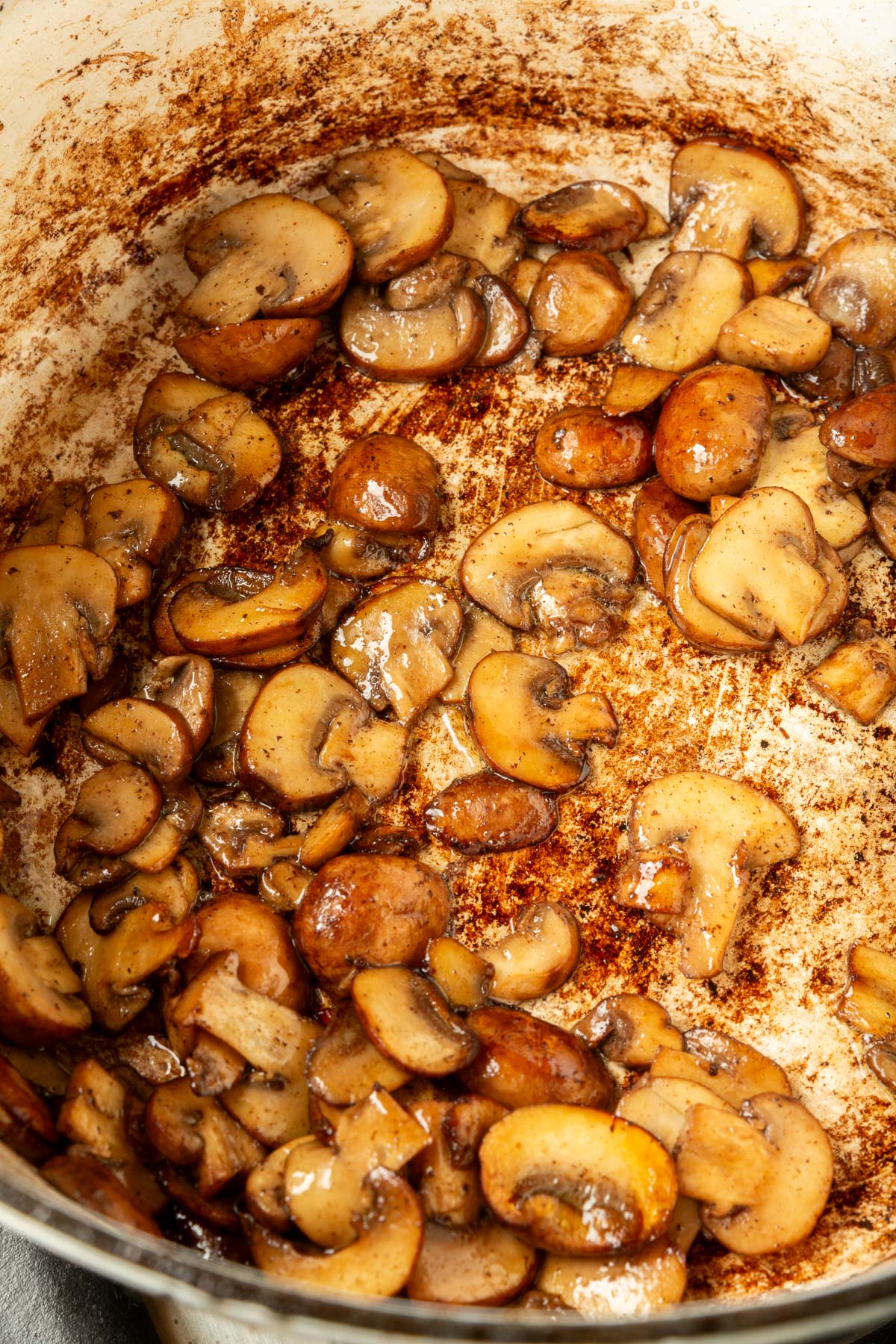 Close up image of sautéed mushrooms in a large pot.