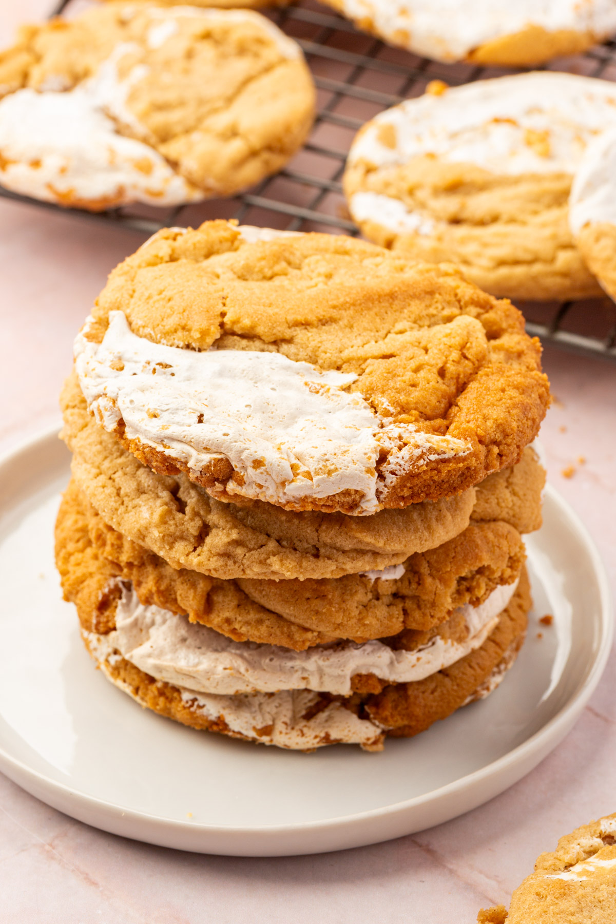 Image of gluten-free fluffernutter cookeis stacked on a white plate.