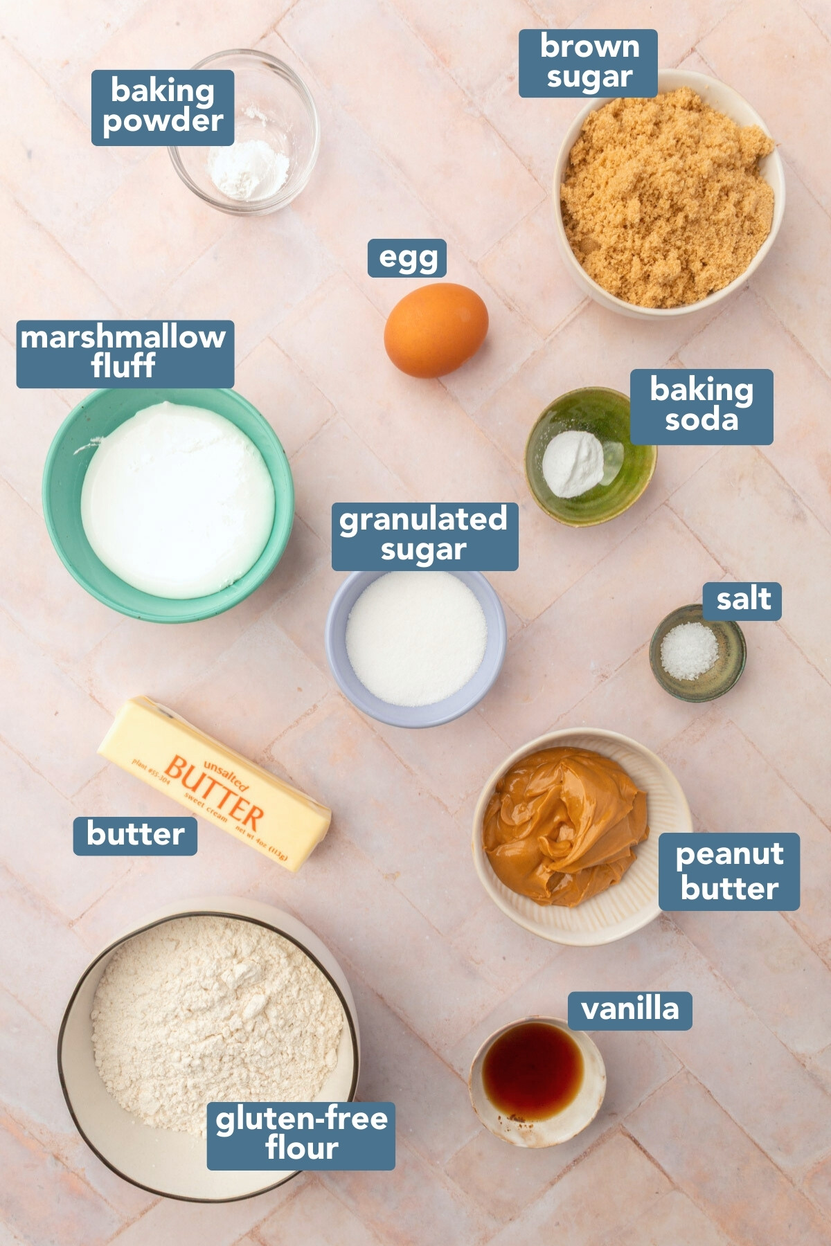 Image of ingredients needed for gluten-free fluffernutter cookies including, marshmallow fluff, egg, baking soda, granulated sugar, salt, peanut butter, butter, vanilla, light brown sugar and gluten-free flour.