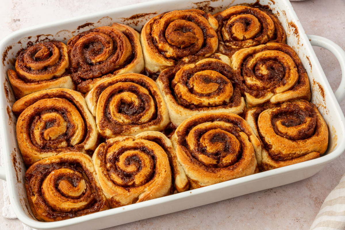 Pan of baked gluten-free cinnamon rolls with golden brown tops.