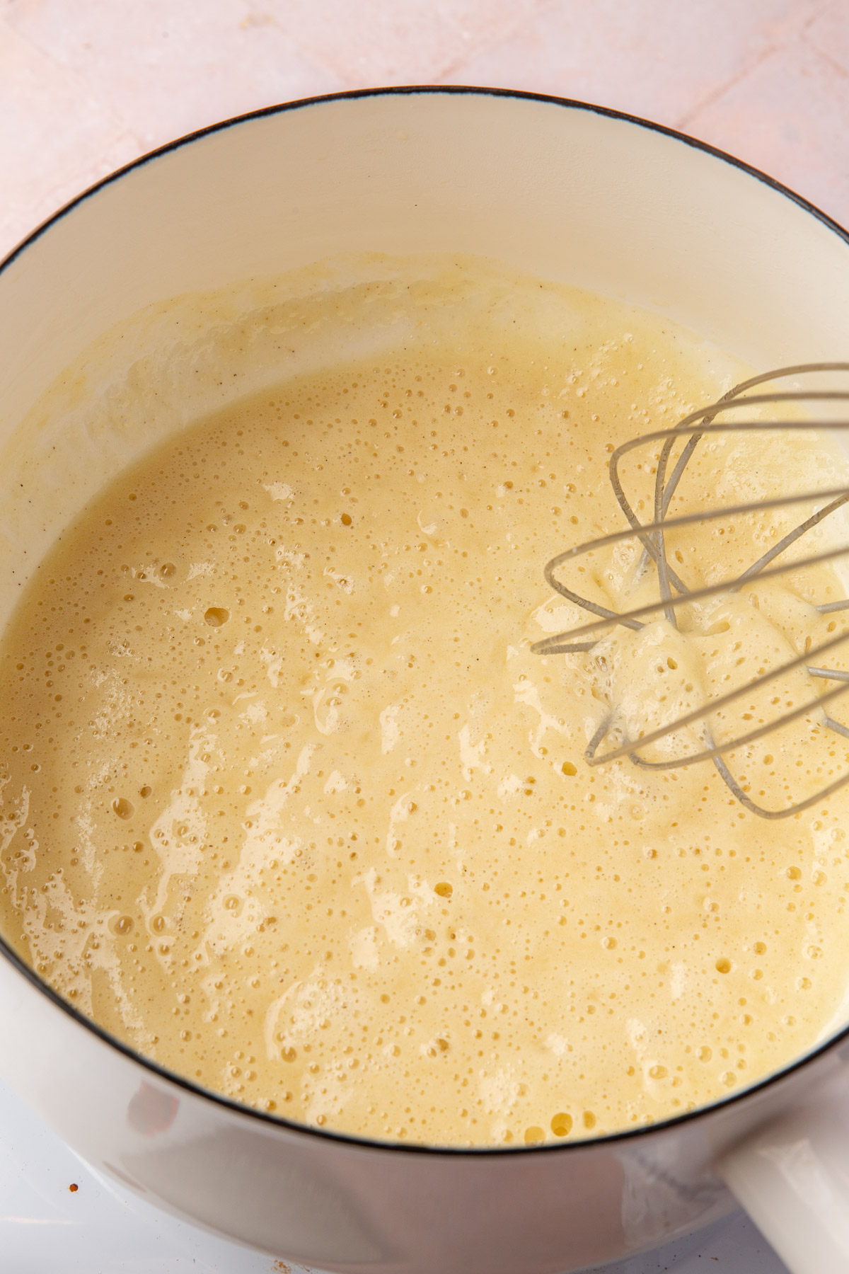 Gluten-free roux cooking to a light golden color with small bubbles forming.