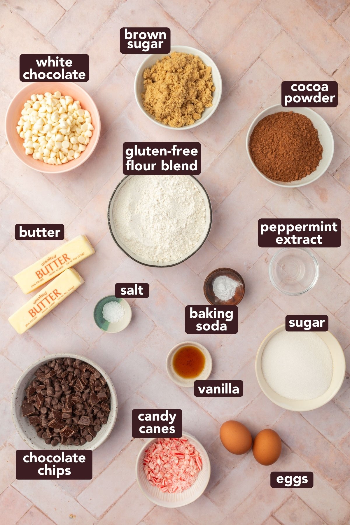 Ingredients for gluten-free chocolate peppermint cookies including flour, cocoa powder, butter, sugars, eggs, chocolate chips, white chocolate, and crushed candy canes with text labels.