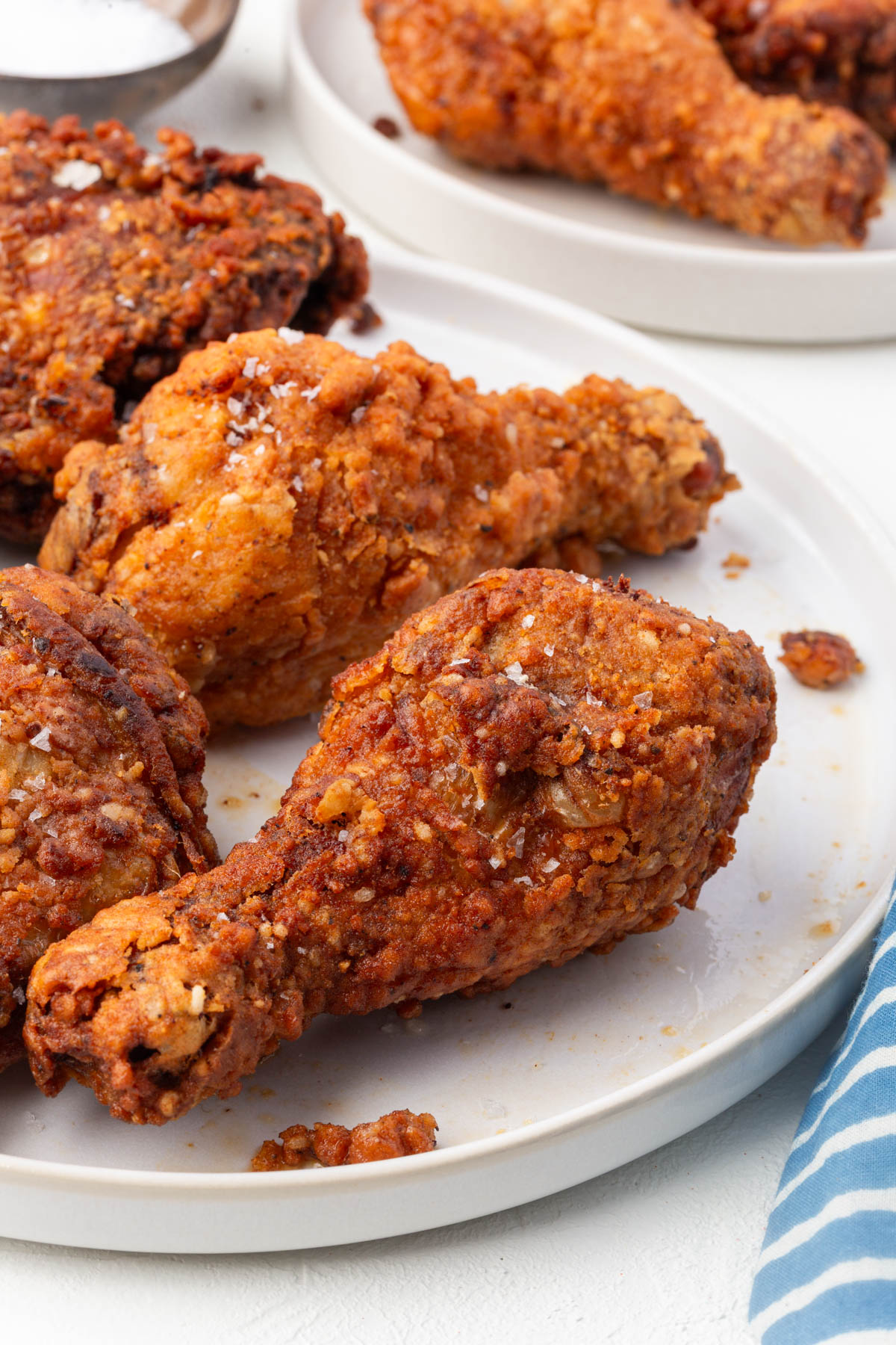 Golden brown gluten-free fried chicken drumstick showing crispy coating texture.