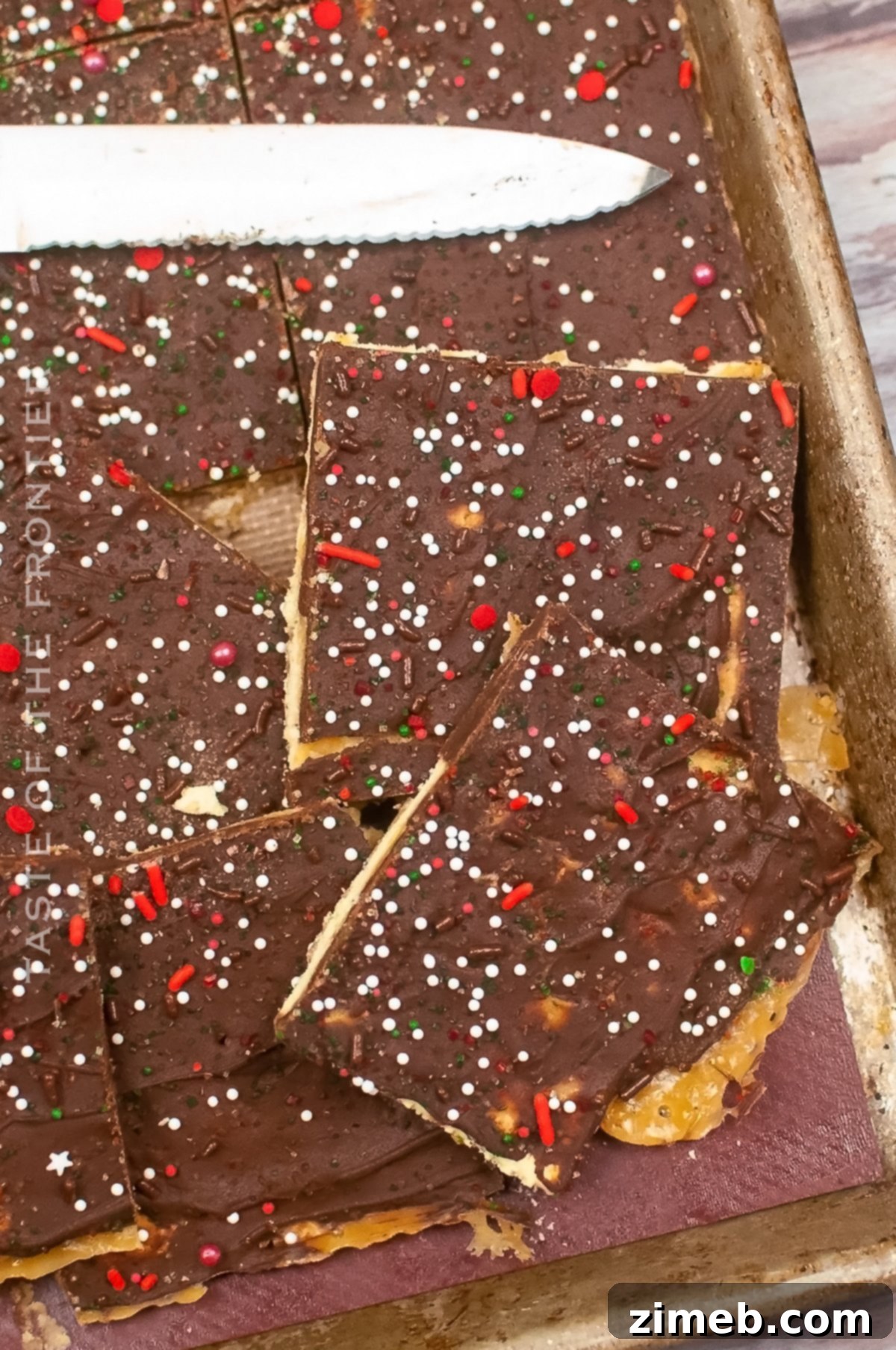 Yuletide Toffee Bliss 16 A large pile of freshly broken Christmas Crack pieces, ready to be served or packaged as gifts, featuring the chocolate and sprinkles atop the crunchy toffee layer.