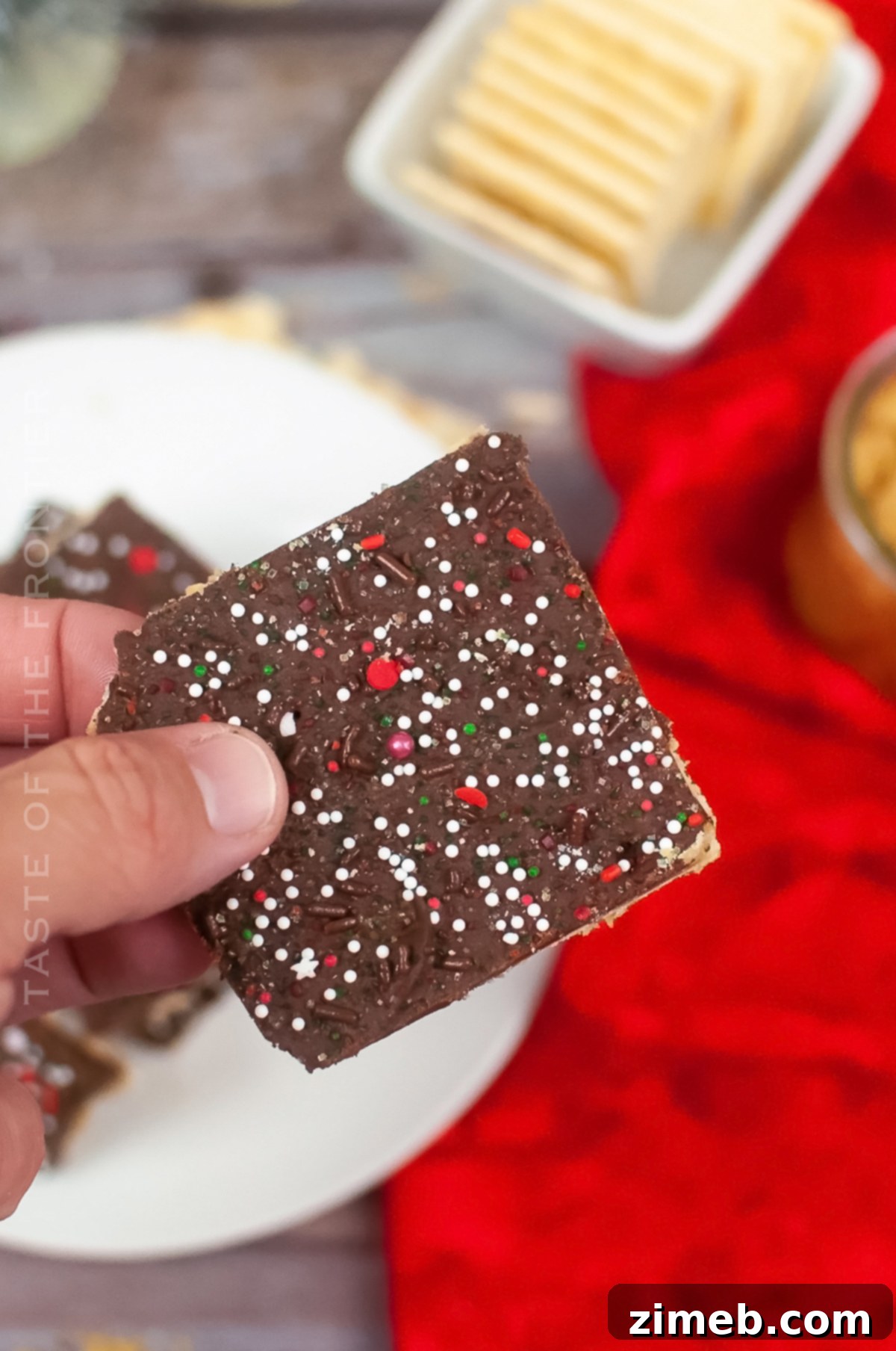 Yuletide Toffee Bliss 9 A festive platter of Christmas Crack with vibrant red and green sprinkles, showcasing its visual appeal and crunchy texture.