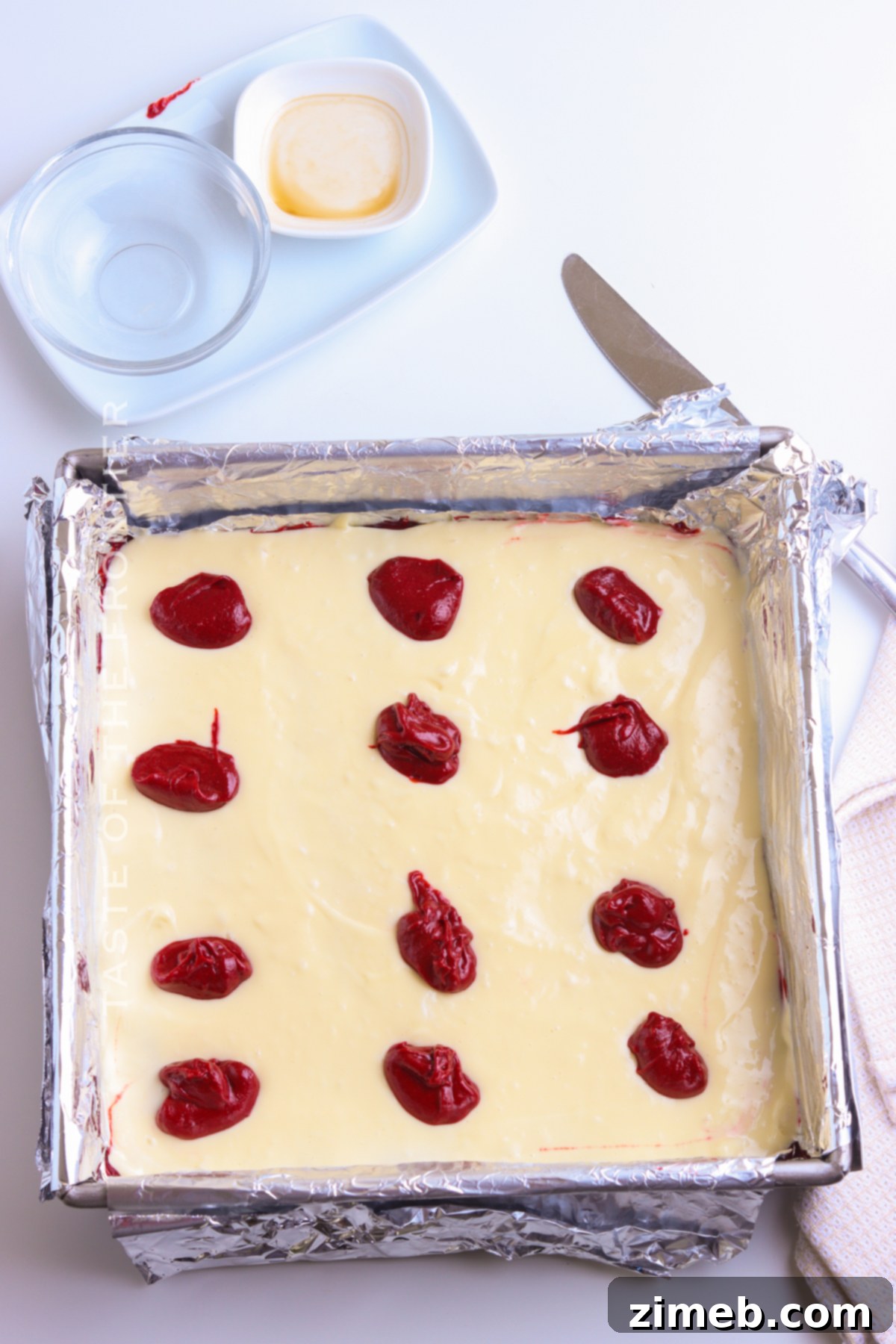 Adding topping to red velvet cream cheese brownies