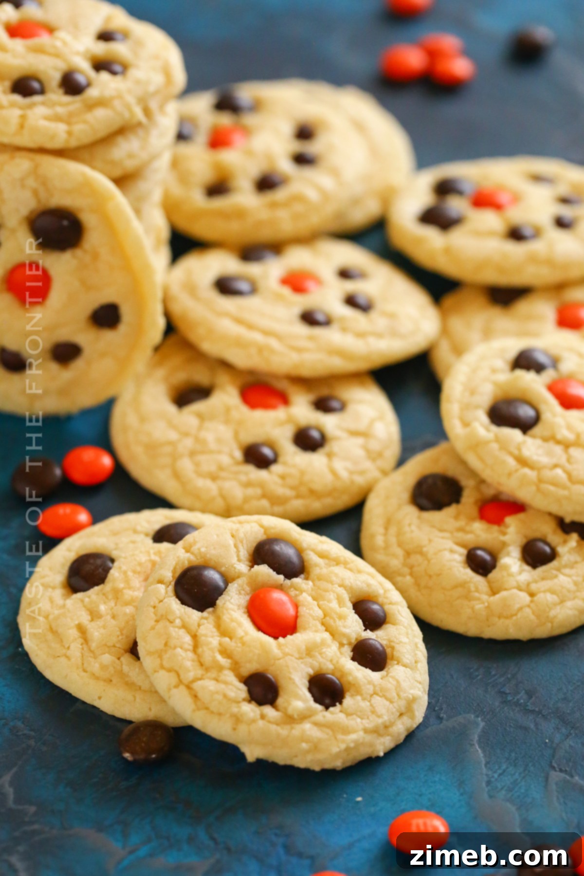 Festive Snowman Cookies 3 Two easy holiday snowman cookies on a cooling rack.