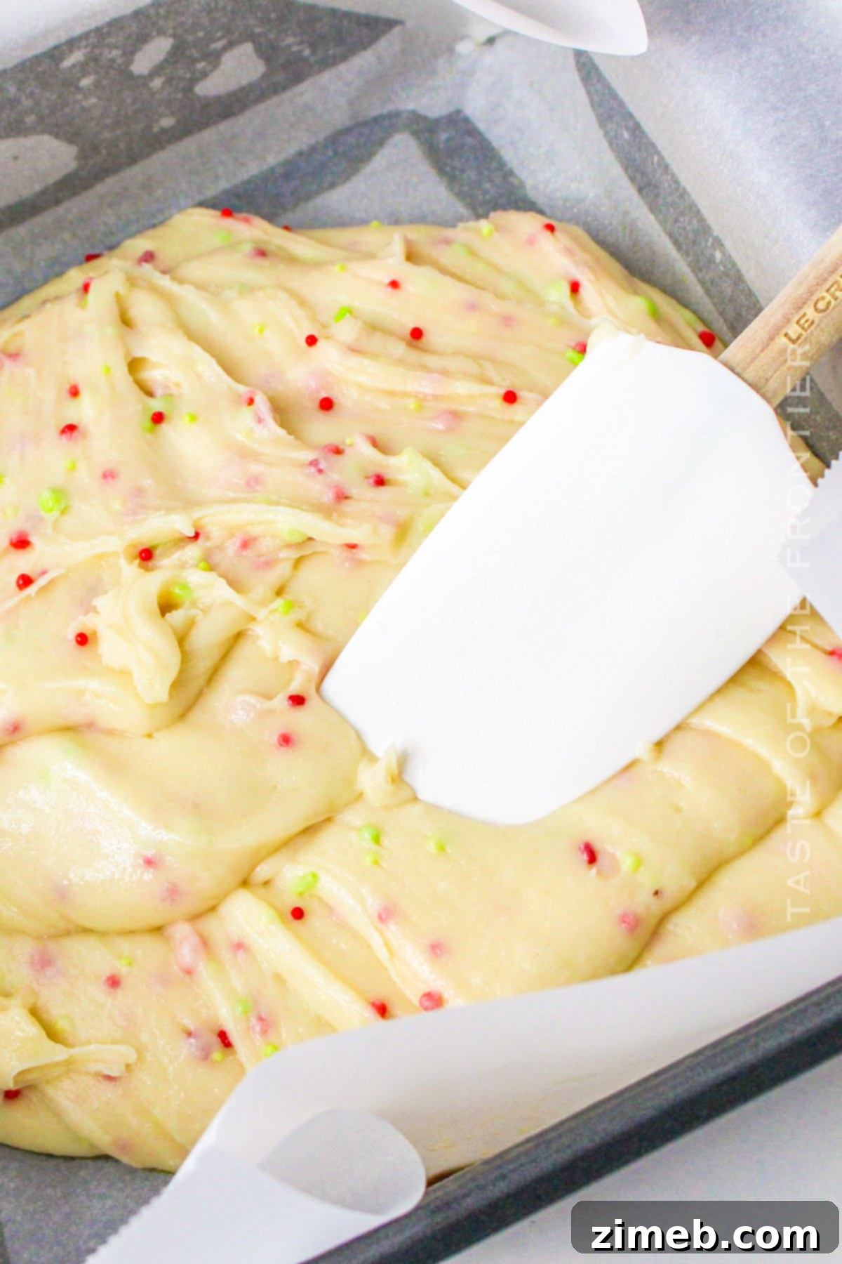 Decadent Christmas Cookie Fudge 7 spreading Christmas Cookie Fudge in the pan