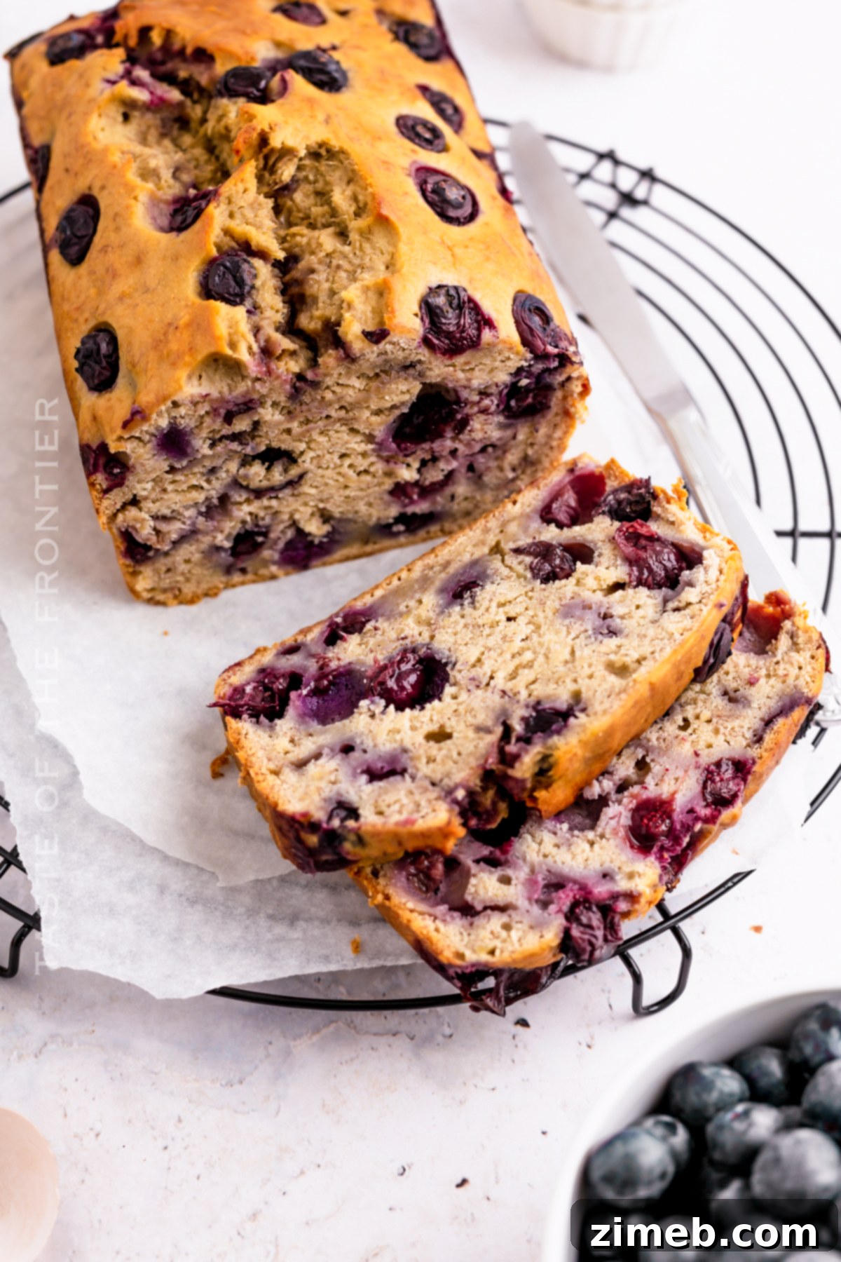 Golden Banana Blueberry Loaf 15 Close-up of baked banana bread with blueberries