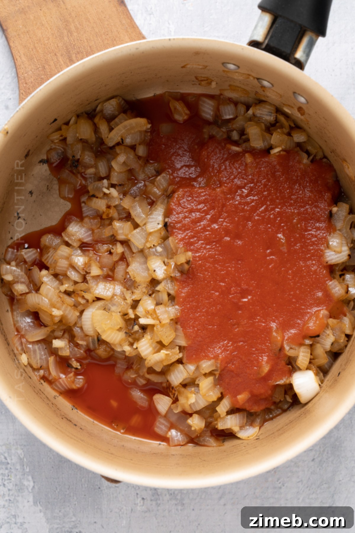 Process shot of how to make homemade marinara sauce for chicken parmesan.