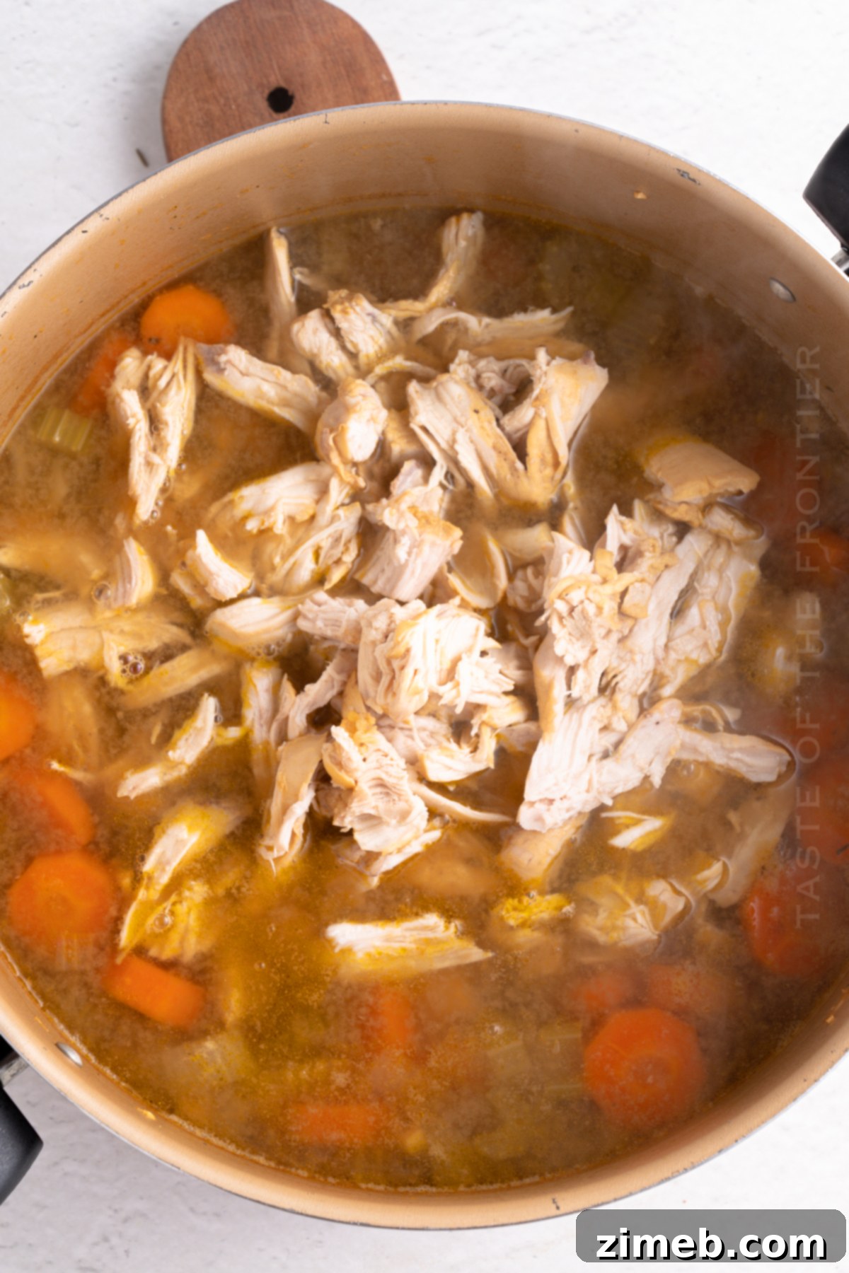 Hearty Chicken Noodle Comfort 8 Close-up of perfectly shredded chicken breast, ready to be added back into the soup.