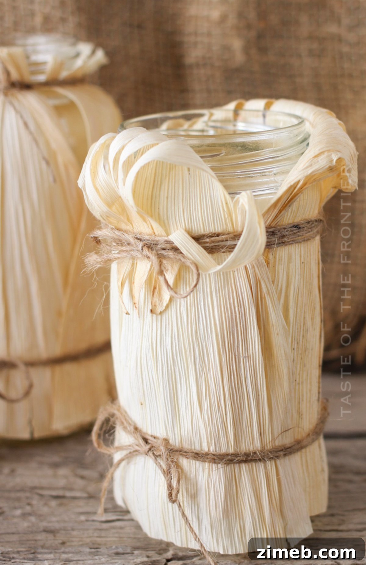 Detailed view of how to make corn husk luminaries, showing husks being wrapped