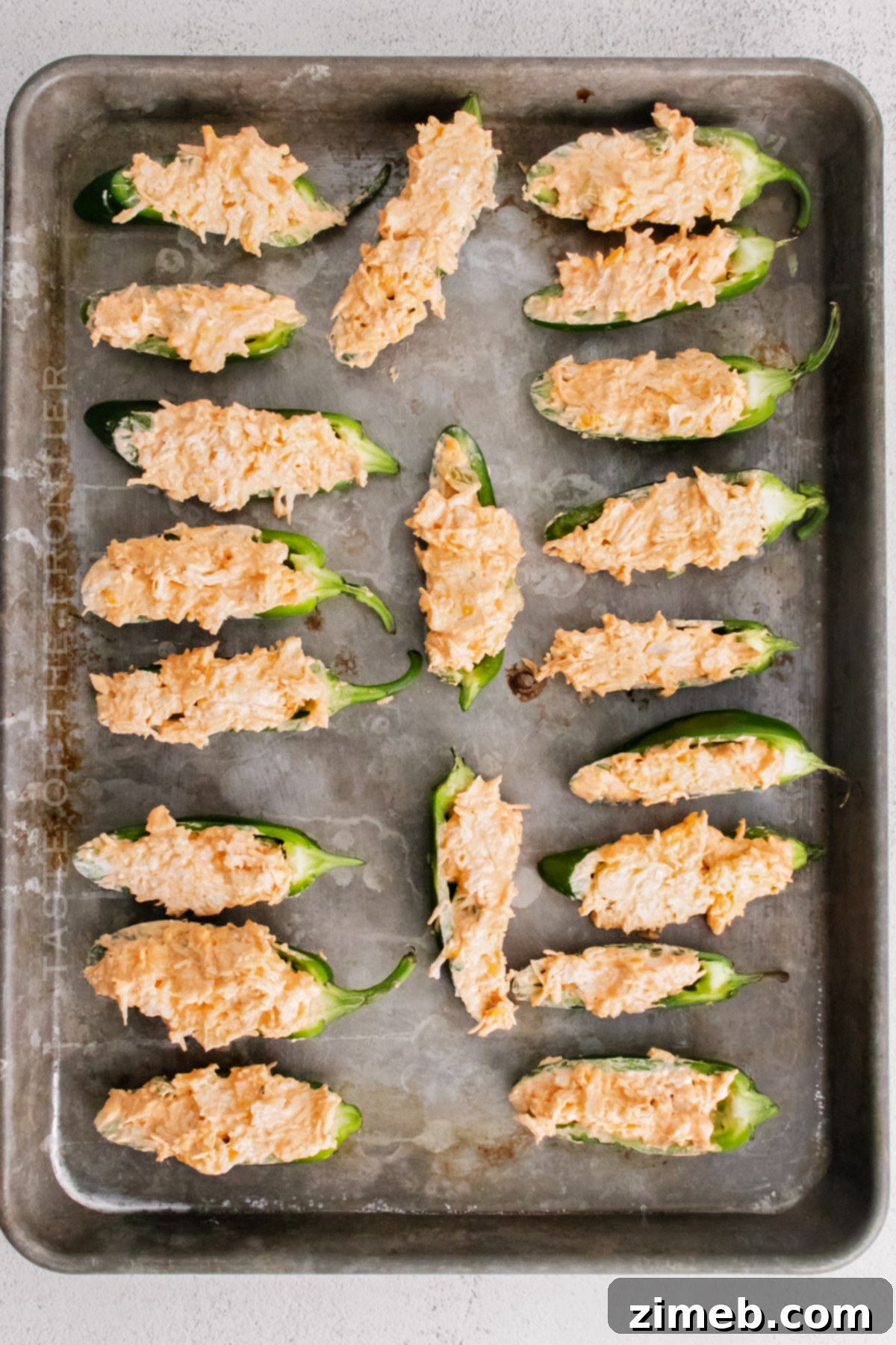 Baked Jalapeno Poppers cooking in the oven on a baking sheet