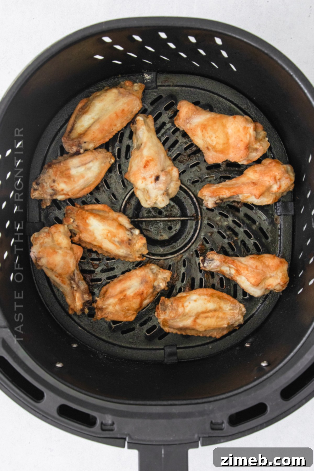 Sticky Honey-Glazed Chicken Wings 7 Cooked air fried chicken wings in the basket