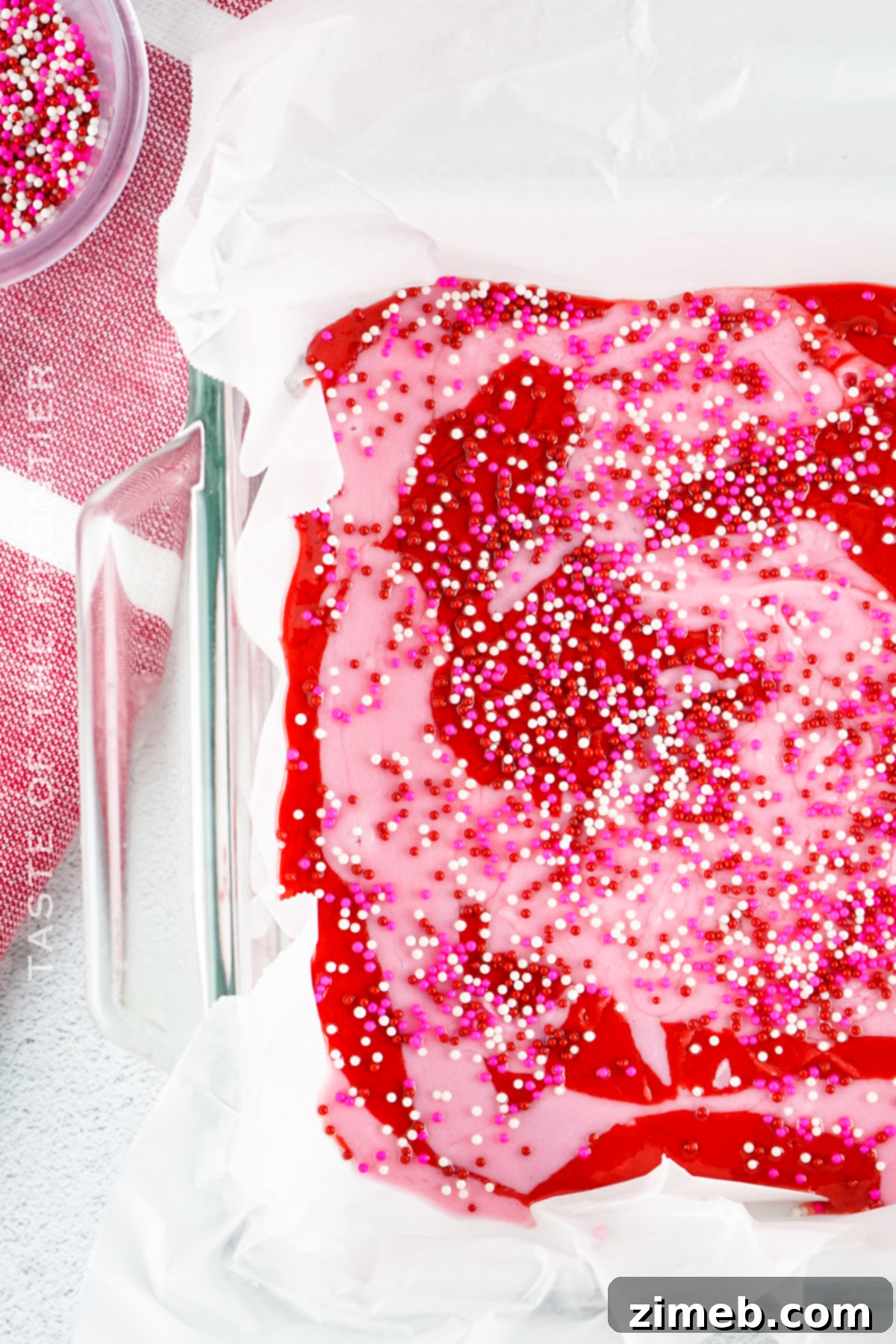 Pink and white sprinkles on strawberry fudge