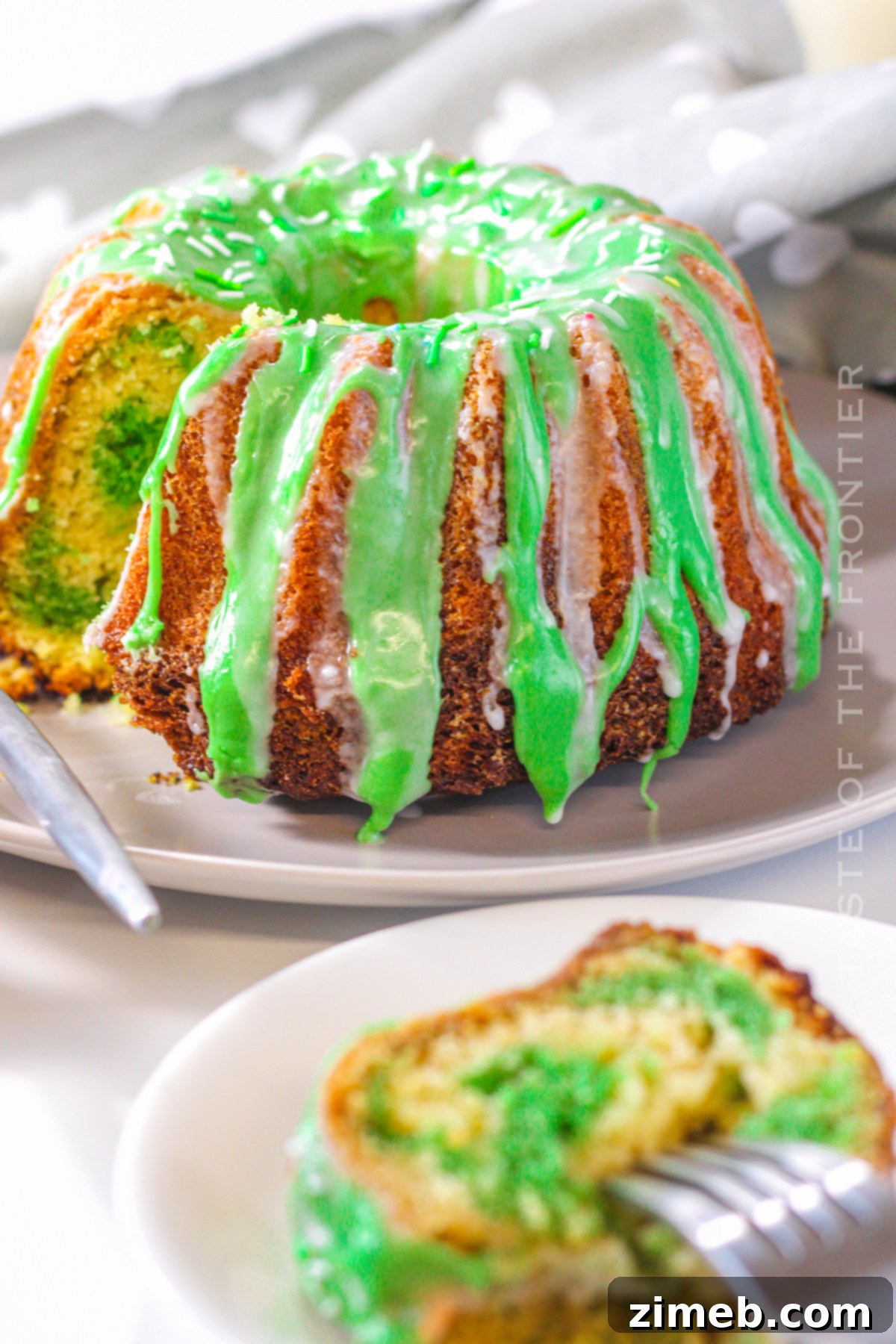 Green bundt cake with white and green icing drizzles, perfect for St. Patrick's Day.
