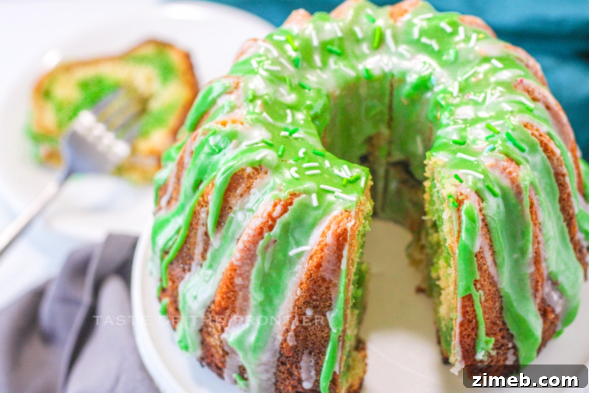 A close-up of vibrant green cake icing being mixed.