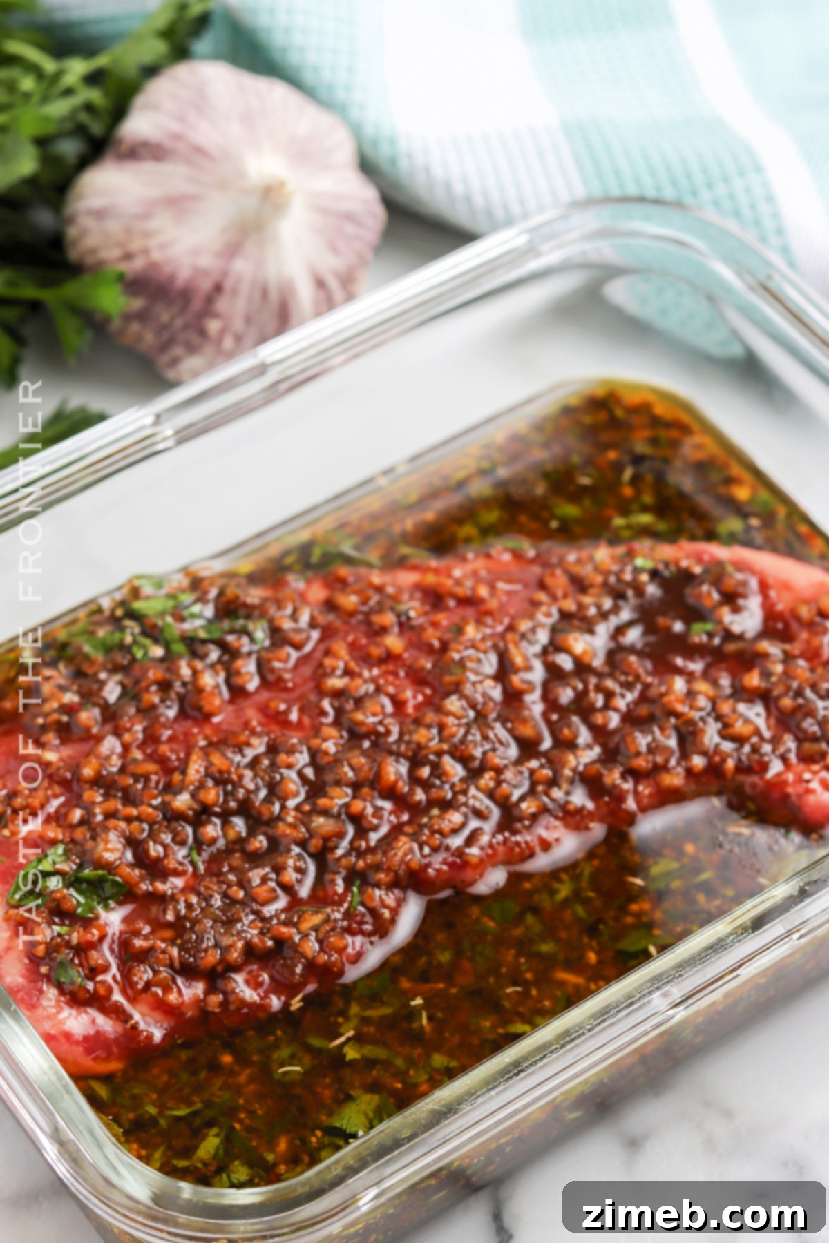 The Only Steak Marinade You'll Ever Need 7 Close-up of beef steak marinating in liquid