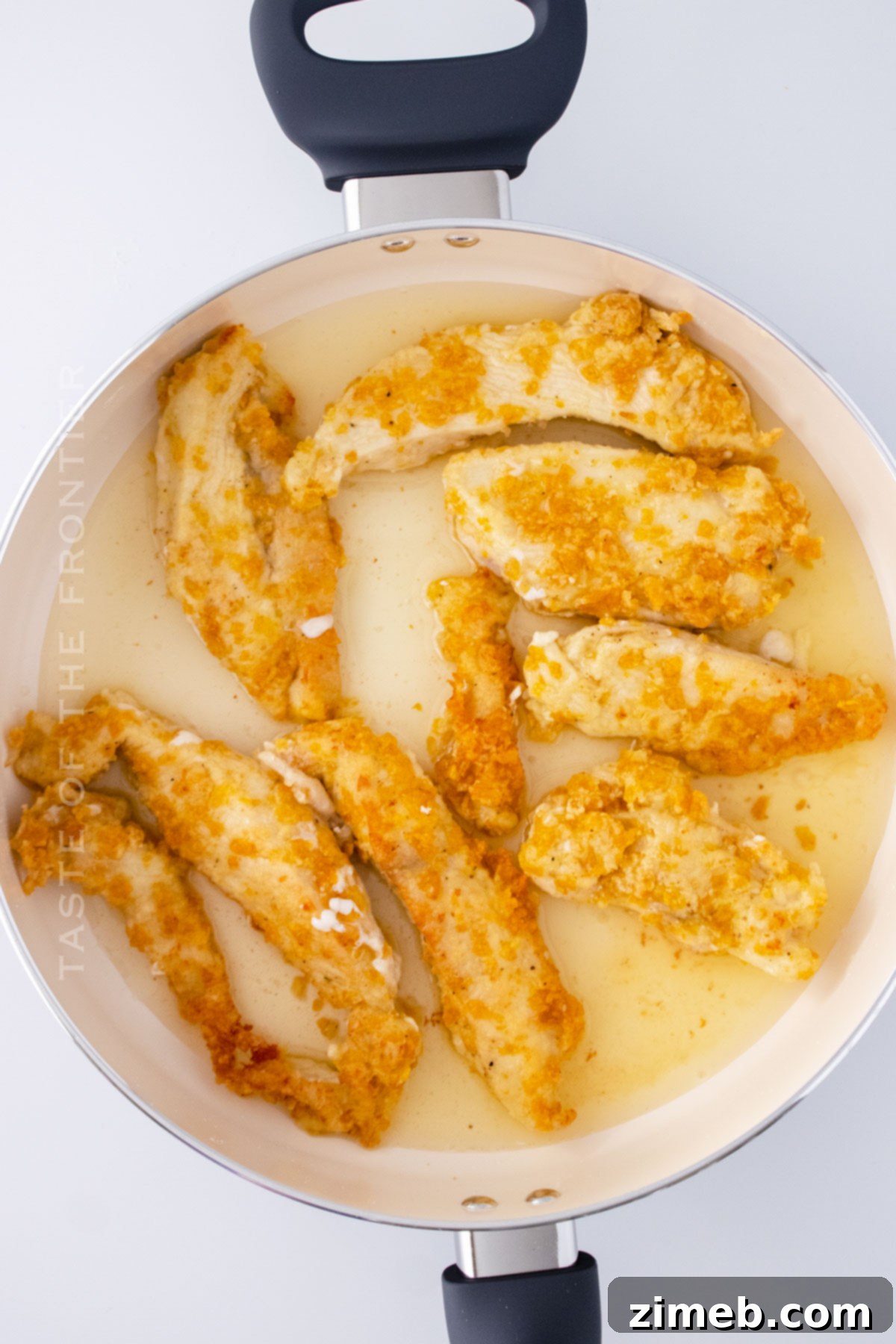 Crispy chicken frying in a pan for the Applebee's Oriental Chicken Salad.