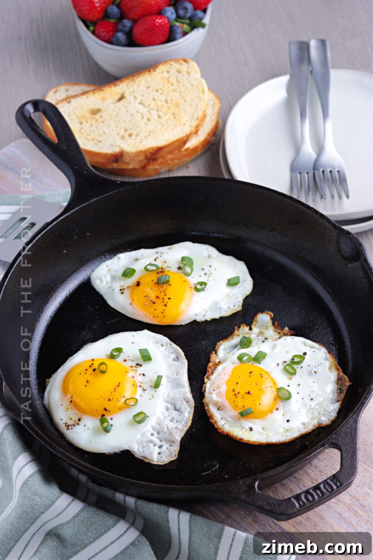 Freshly fried eggs on a plate, ready to be enjoyed for breakfast
