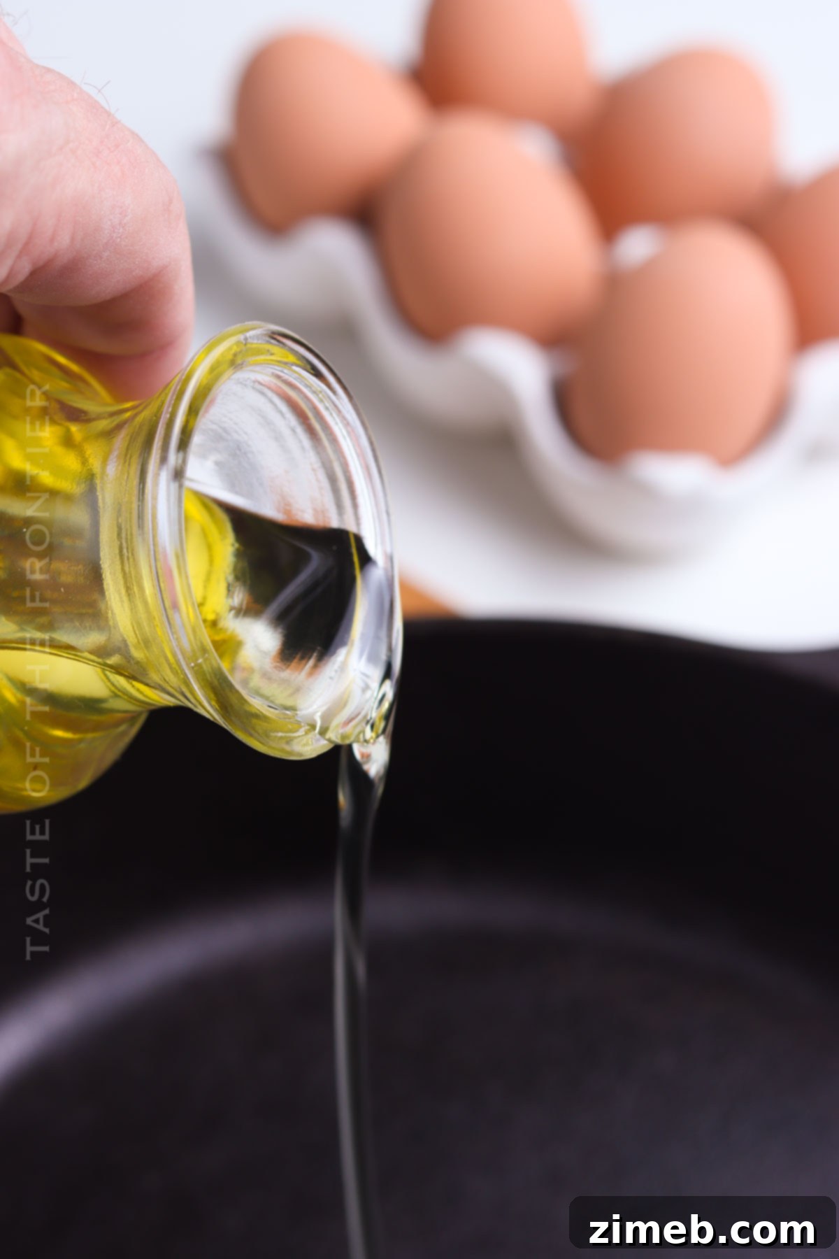 Adding oil to a hot skillet for frying eggs