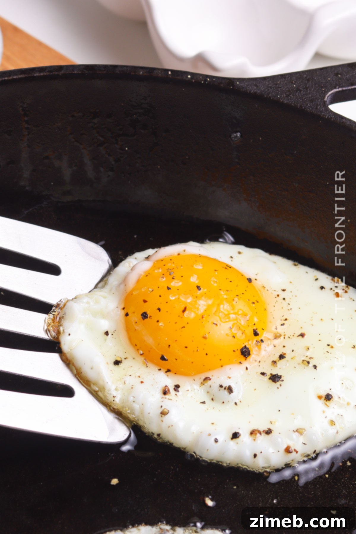 Flipping a fried egg to cook over easy or over medium