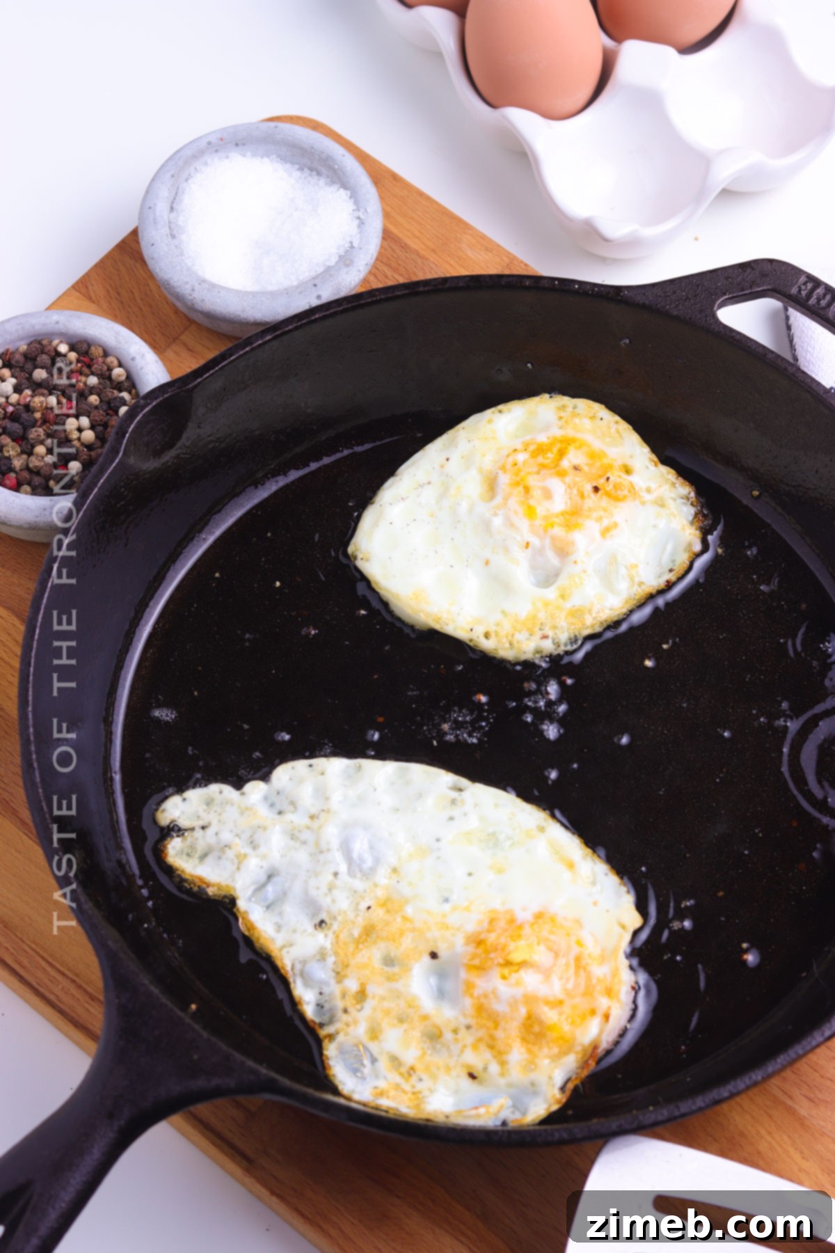 Cooking multiple fried eggs in a skillet for a family breakfast