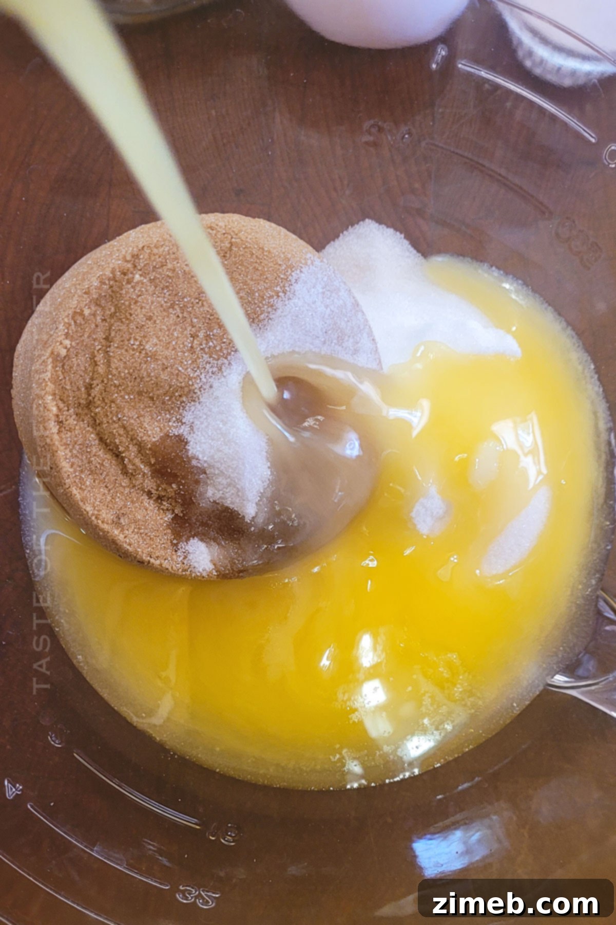 Pouring melted butter into the mixing bowl for Cadbury Egg Cookies