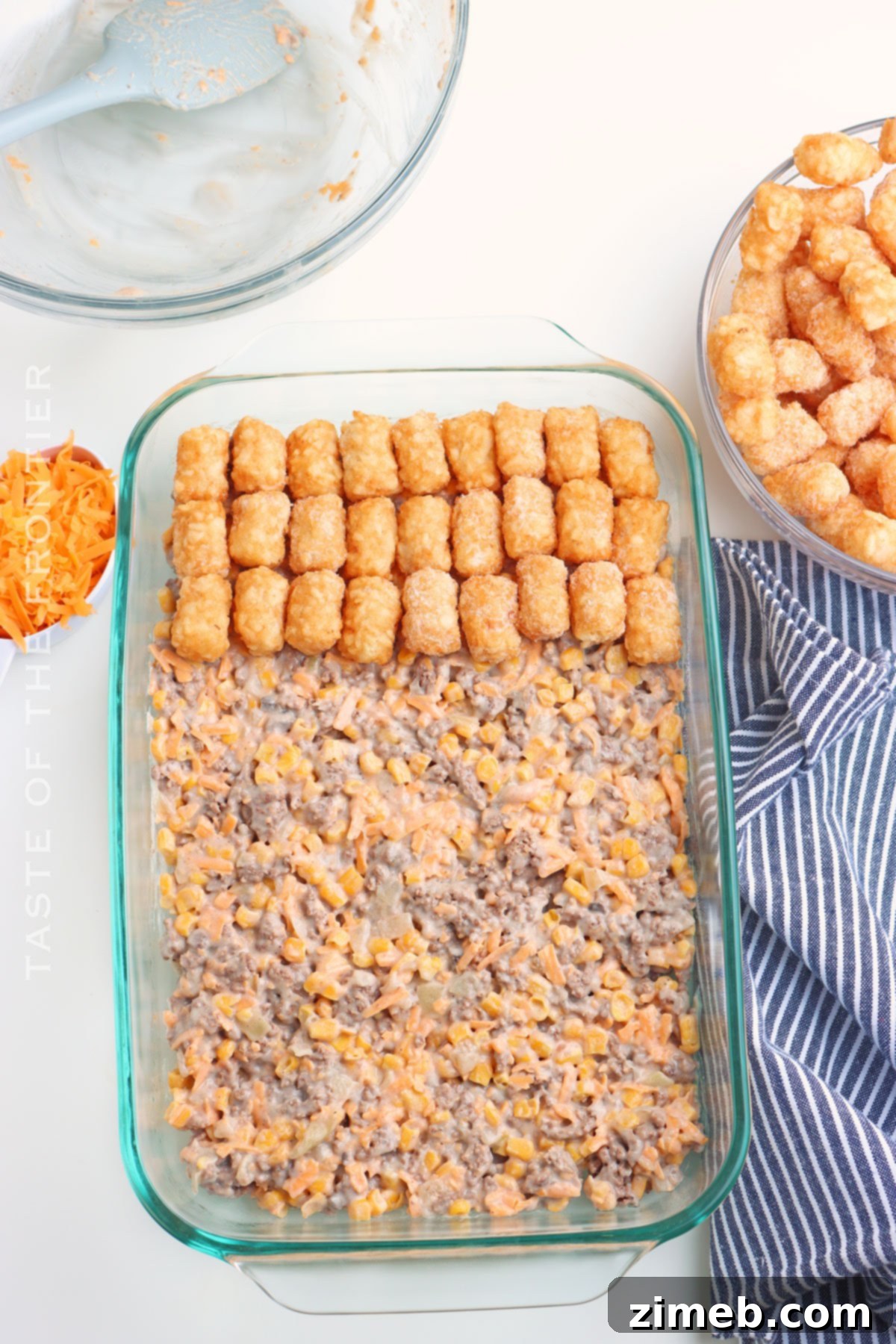 Preparing the casserole with a layer of tater tots