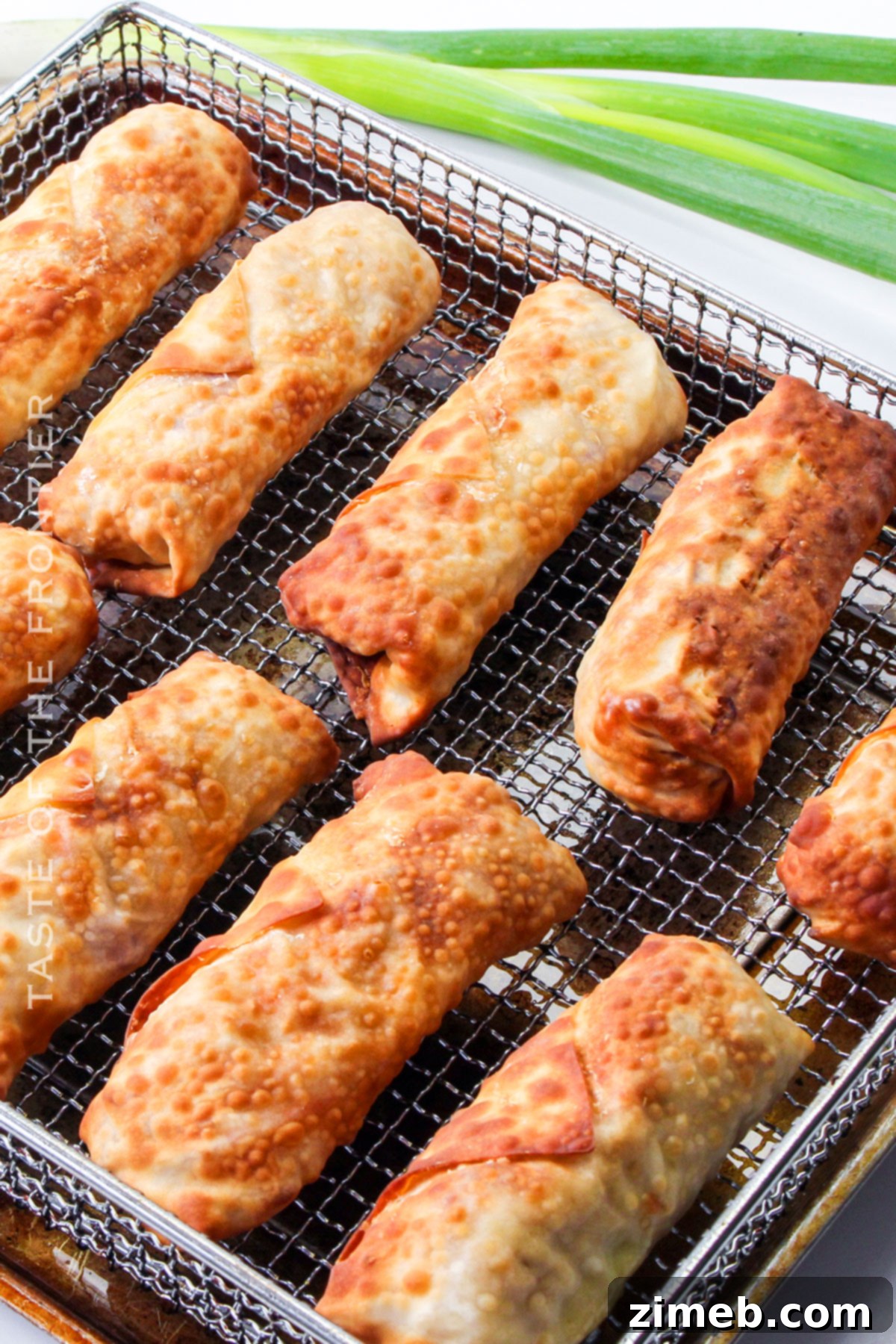 A basket full of air-fried crispy chicken egg rolls and other air-fried snacks, ready to be enjoyed.