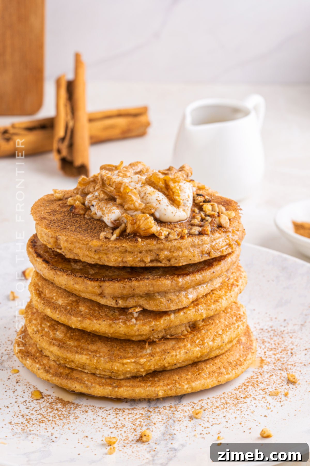 Wholesome Oat Pancakes 15 A tall stack of fluffy oat flour pancakes with syrup cascading down the sides and fresh berries.