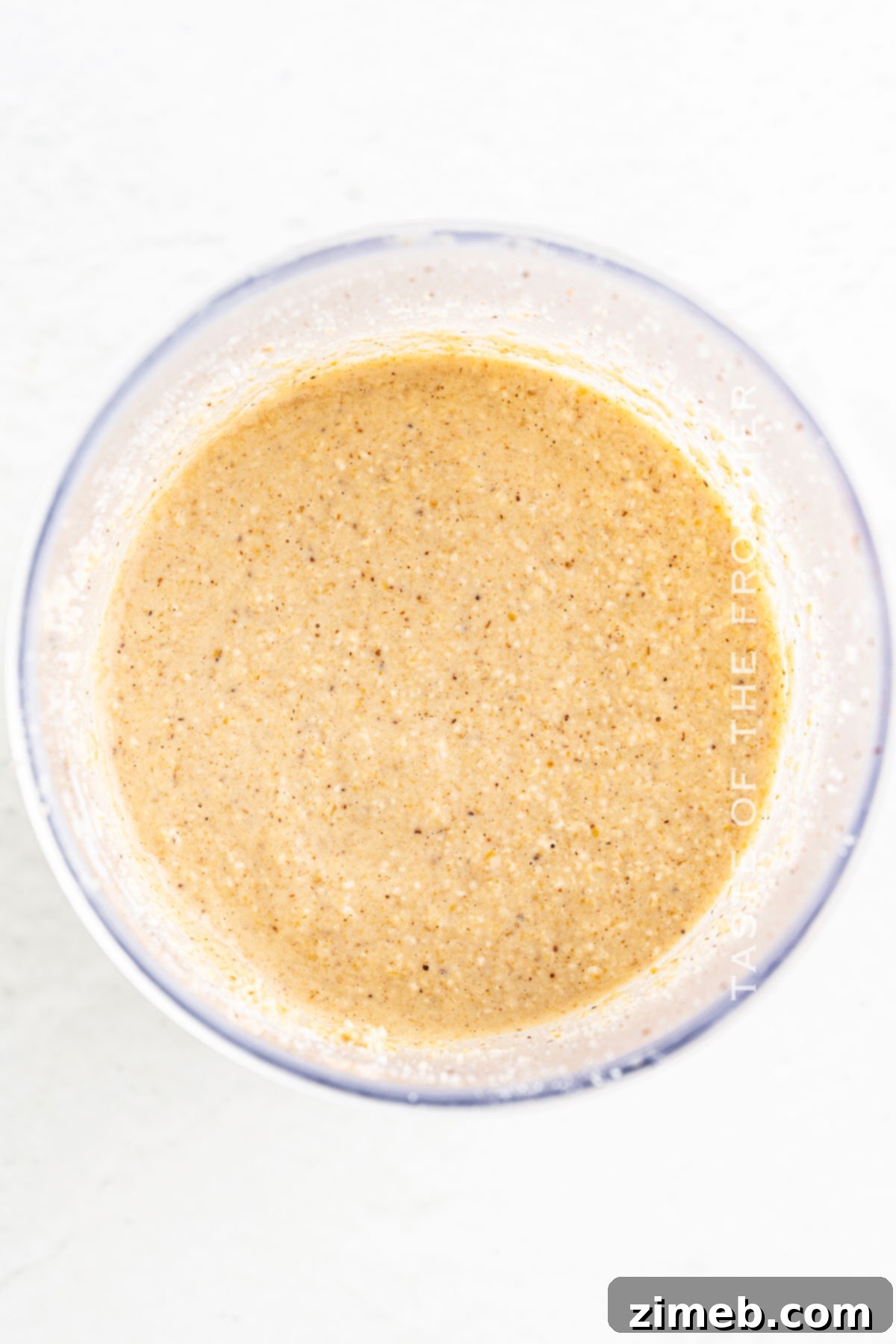 Wholesome Oat Pancakes 5 A bowl of thick, golden oat flour pancake batter, ready to be cooked on a griddle.