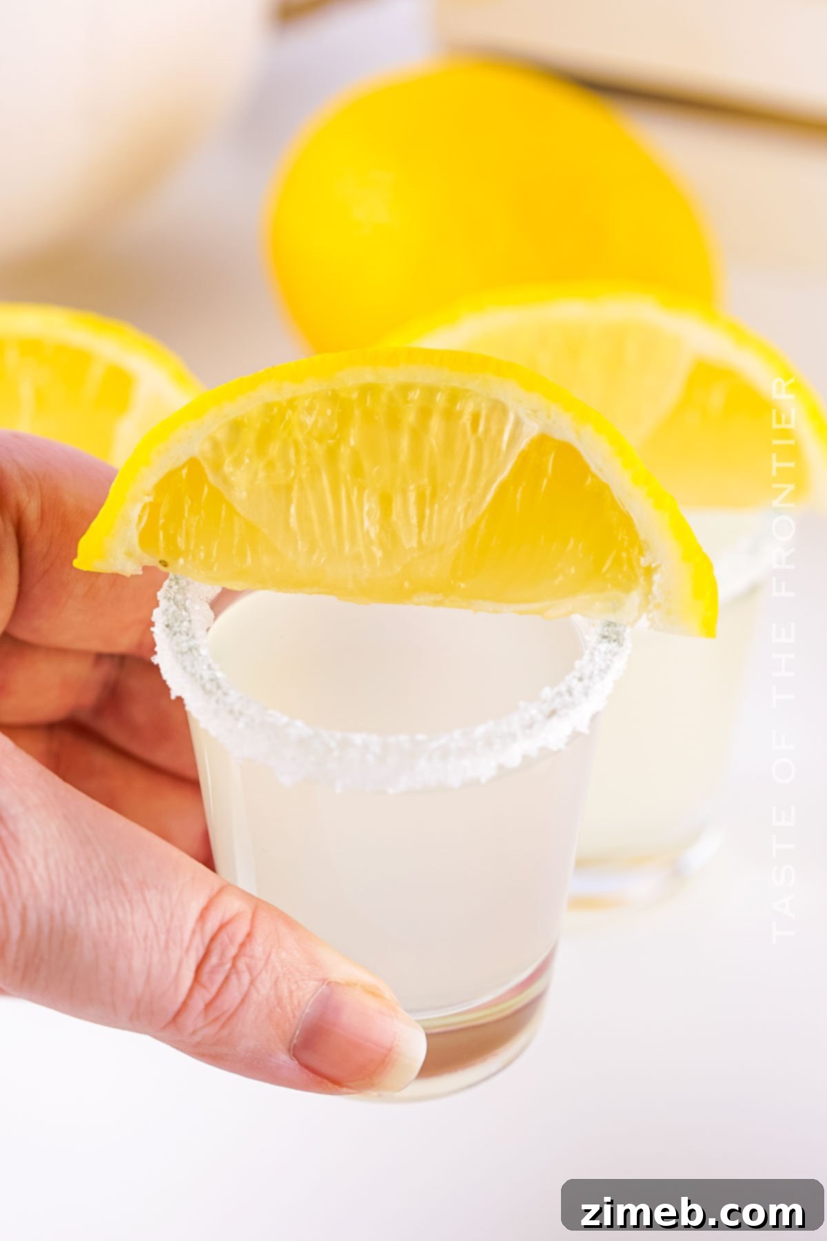 A shot glass with a perfectly sugared rim, ready to be filled with a delicious lemon drop shot.