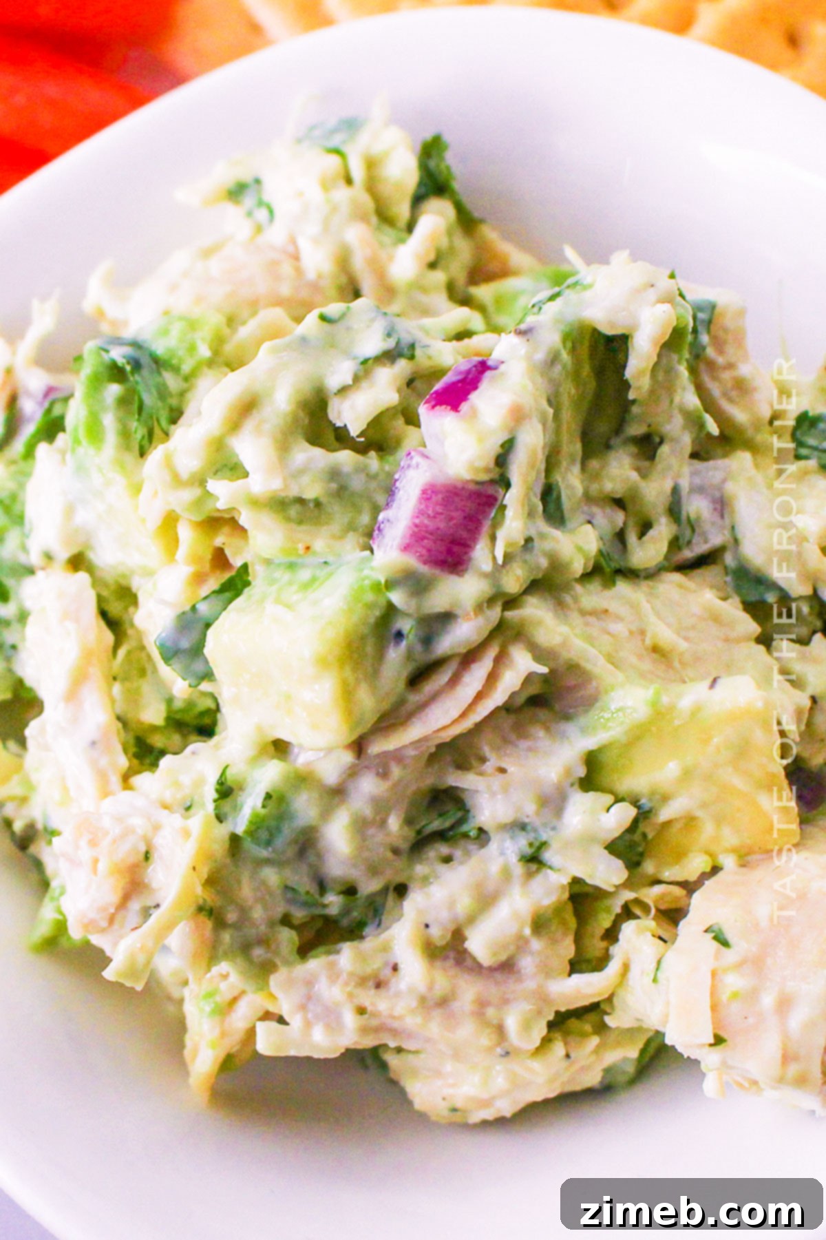 Easy Creamy Avocado Chicken Salad 15 Ingredients for Avocado Chicken Salad in separate piles on a rustic wooden board.