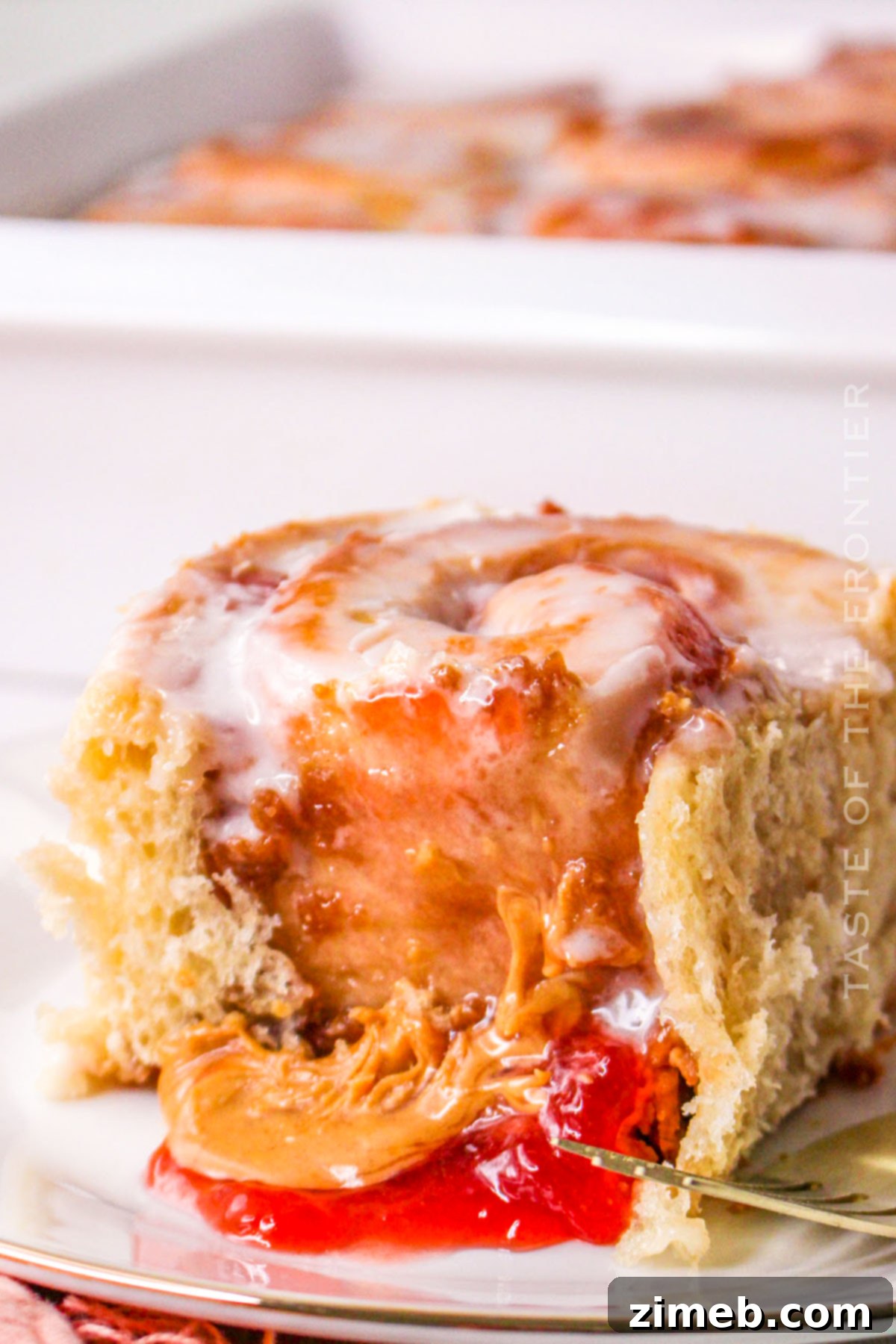 Decadent Peanut Butter Cinnamon Buns 2 Peanut Butter and Jelly Cinnamon Rolls with warm, melty filling and sweet icing